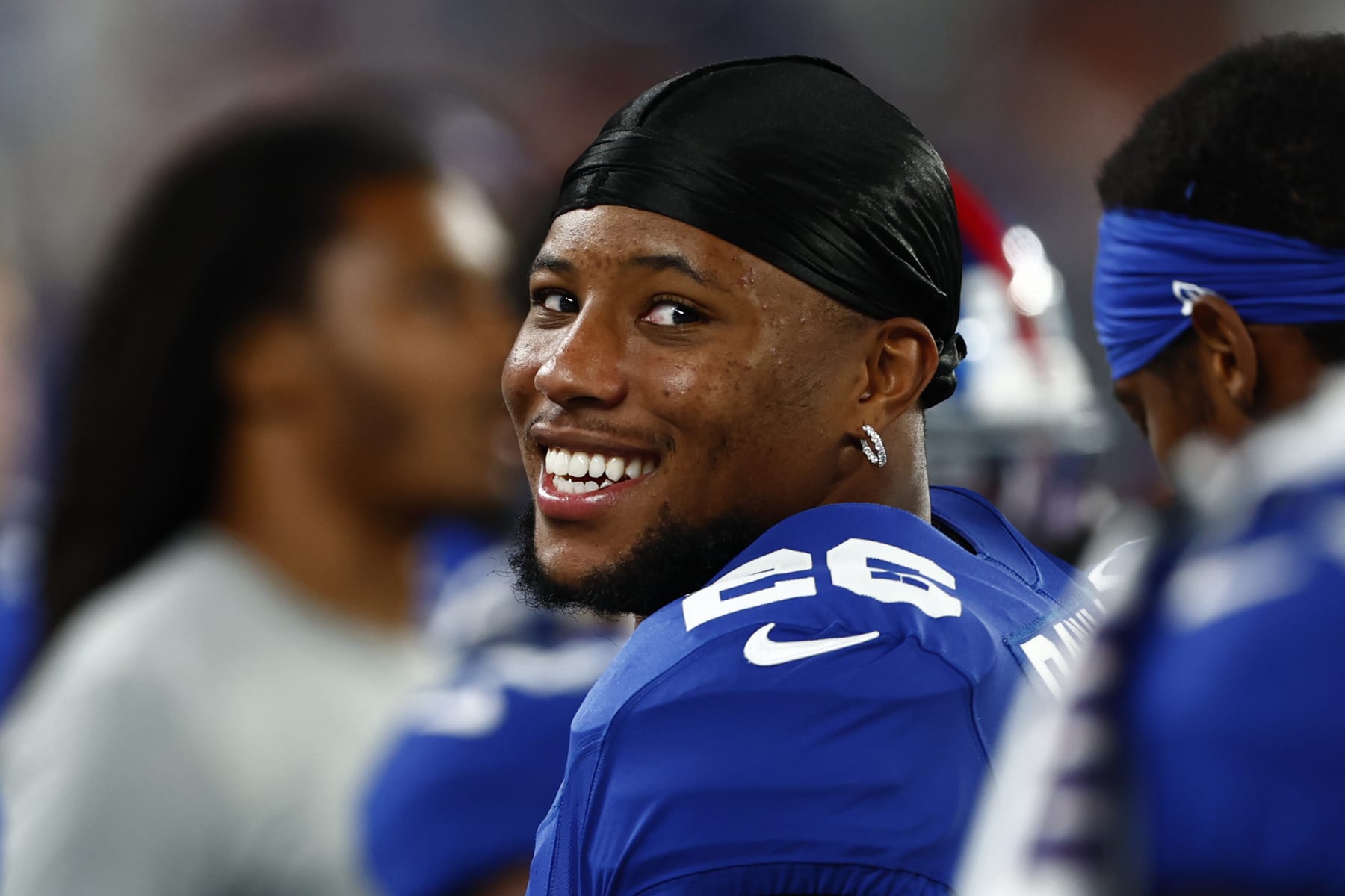 EAST RUTHERFORD, NEW JERSEY - AUGUST 18: Saquon Barkley #26 of the New York Giants looks on from the bench during the second half of a preseason football game against the Carolina Panthers at MetLife Stadium on August 18, 2023 in East Rutherford, New Jersey. The Giants defeated the Giants 21-19. (Photo by Rich Schultz/Getty Images)