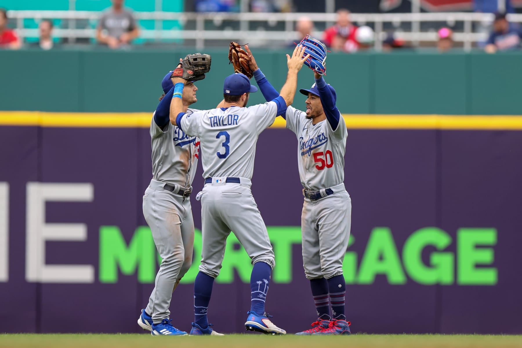 CLEVELAND, OH - AUGUST 24: Los Angeles Dodgers center fielder James Outman (33), Los Angeles Dodgers left fielder Chris Taylor (3) and Los Angeles Dodgers right fielder Mookie Betts (50) celebrate following the Major League Baseball game between the Los Angeles Dodgers and Cleveland Guardians on August 24, 2023, at Progressive Field in Cleveland, OH. This was the completion of the game suspended due to weather on August 23, 2023. (Photo by Frank Jansky/Icon Sportswire via Getty Images)