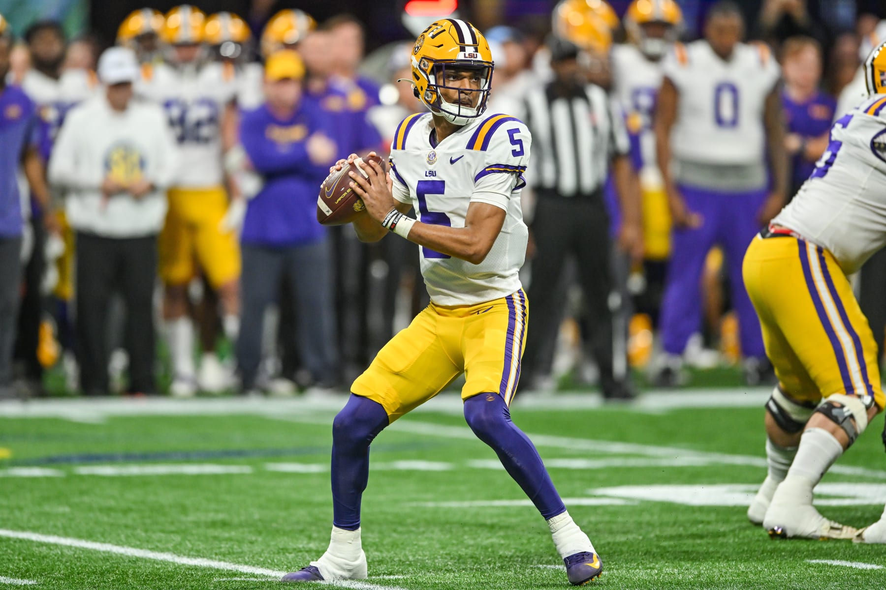 ATLANTA, GA - DECEMBER 03:  LSU quarterback Jayden Daniels (5) drops back to pass during the SEC Championship football game between the LSU Tigers and the Georgia Bulldogs on December 3rd, 2022 at Mercedes-Benz Stadium in Atlanta, GA. (Photo by Rich von Biberstein/Icon Sportswire via Getty Images)