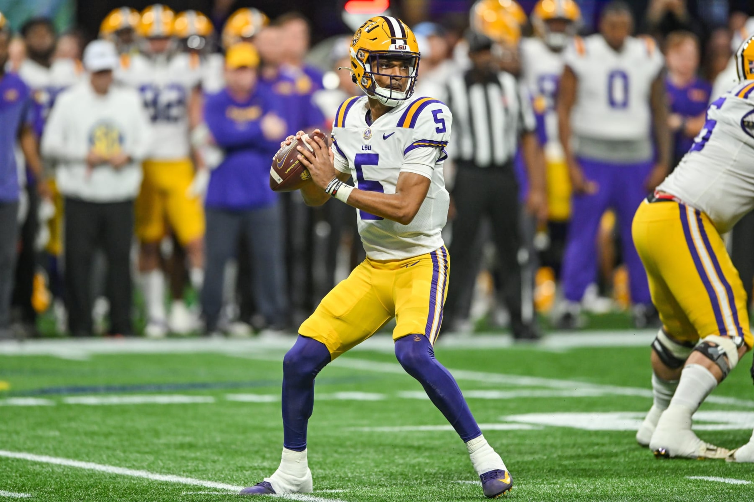 ATLANTA, GA - DECEMBER 03:  LSU quarterback Jayden Daniels (5) drops back to pass during the SEC Championship football game between the LSU Tigers and the Georgia Bulldogs on December 3rd, 2022 at Mercedes-Benz Stadium in Atlanta, GA. (Photo by Rich von Biberstein/Icon Sportswire via Getty Images)