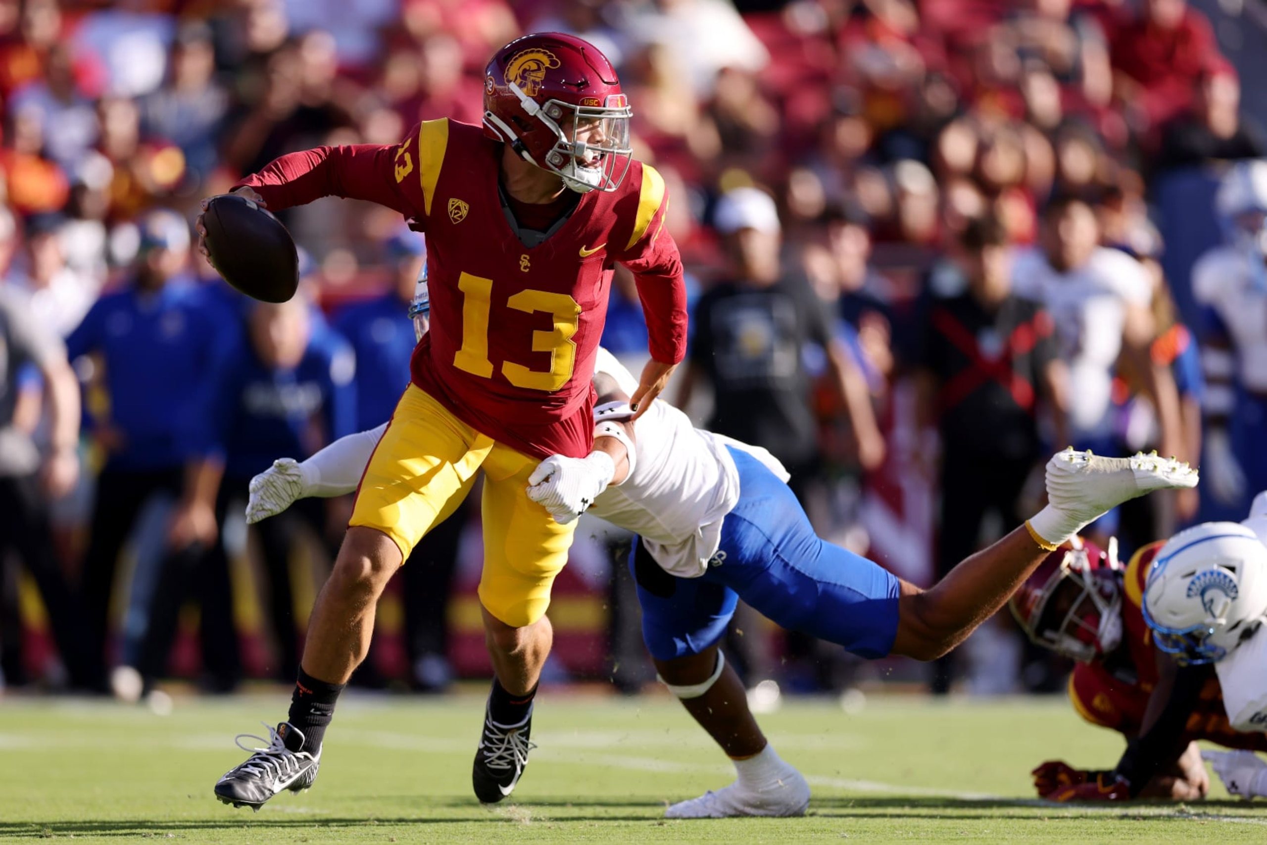 LOS ANGELES, CALIFORNIA - AUGUST 26: Caleb Williams #13 of the USC Trojans avoids the tackle against Elijah Wood #14 of the San Jose State Spartans during the second quarter at United Airlines Field at the Los Angeles Memorial Coliseum on August 26, 2023 in Los Angeles, California. (Photo by Katelyn Mulcahy/Getty Images)