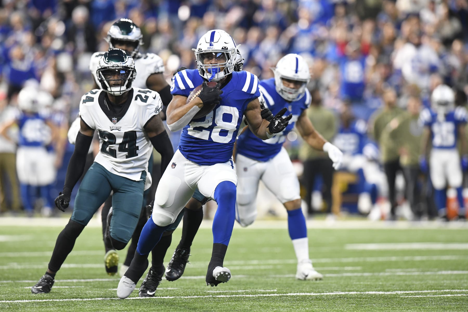 INDIANAPOLIS, IN - NOVEMBER 20: Indianapolis Colts Running Back Jonathan Taylor (28) carries the ball as Philadelphia Eagles Cornerback James Bradberry (24) pursues during the NFL football game between the Philadelphia Eagles and the Indianapolis Colts on November 20, 2022, at Lucas Oil Stadium in Indianapolis, Indiana. (Photo by Michael Allio/Icon Sportswire via Getty Images)