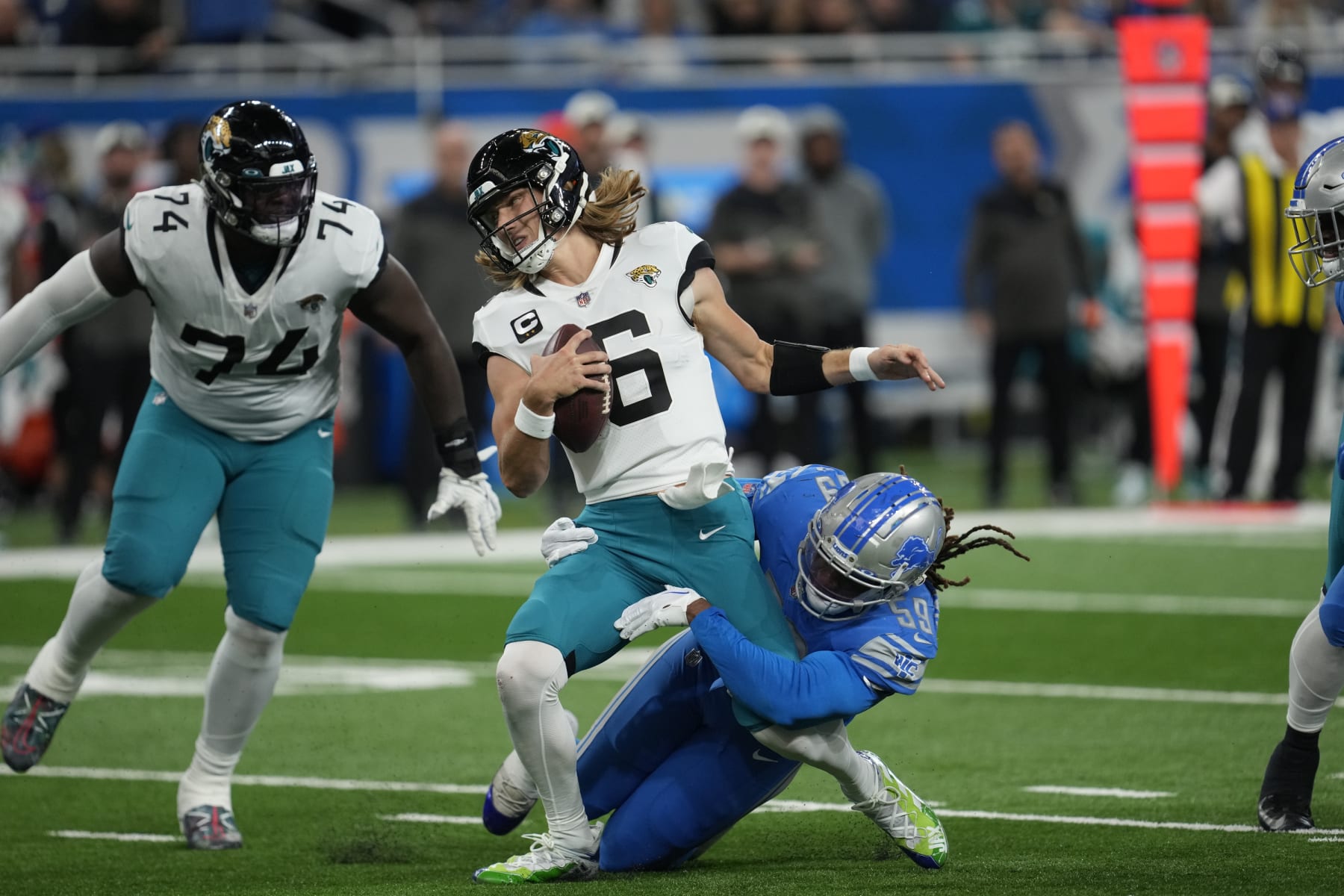Detroit Lions linebacker James Houston (59) sacks Jacksonville Jaguars quarterback Trevor Lawrence (16) during an NFL football game in Detroit, Sunday, Dec. 4, 2022. (AP Photo/Paul Sancya) Detroit Lions linebacker James Houston (59) sacks Jacksonville Jaguars quarterback Trevor Lawrence (16) during an NFL football game in Detroit, Sunday, Dec. 4, 2022. (AP Photo/Paul Sancya)