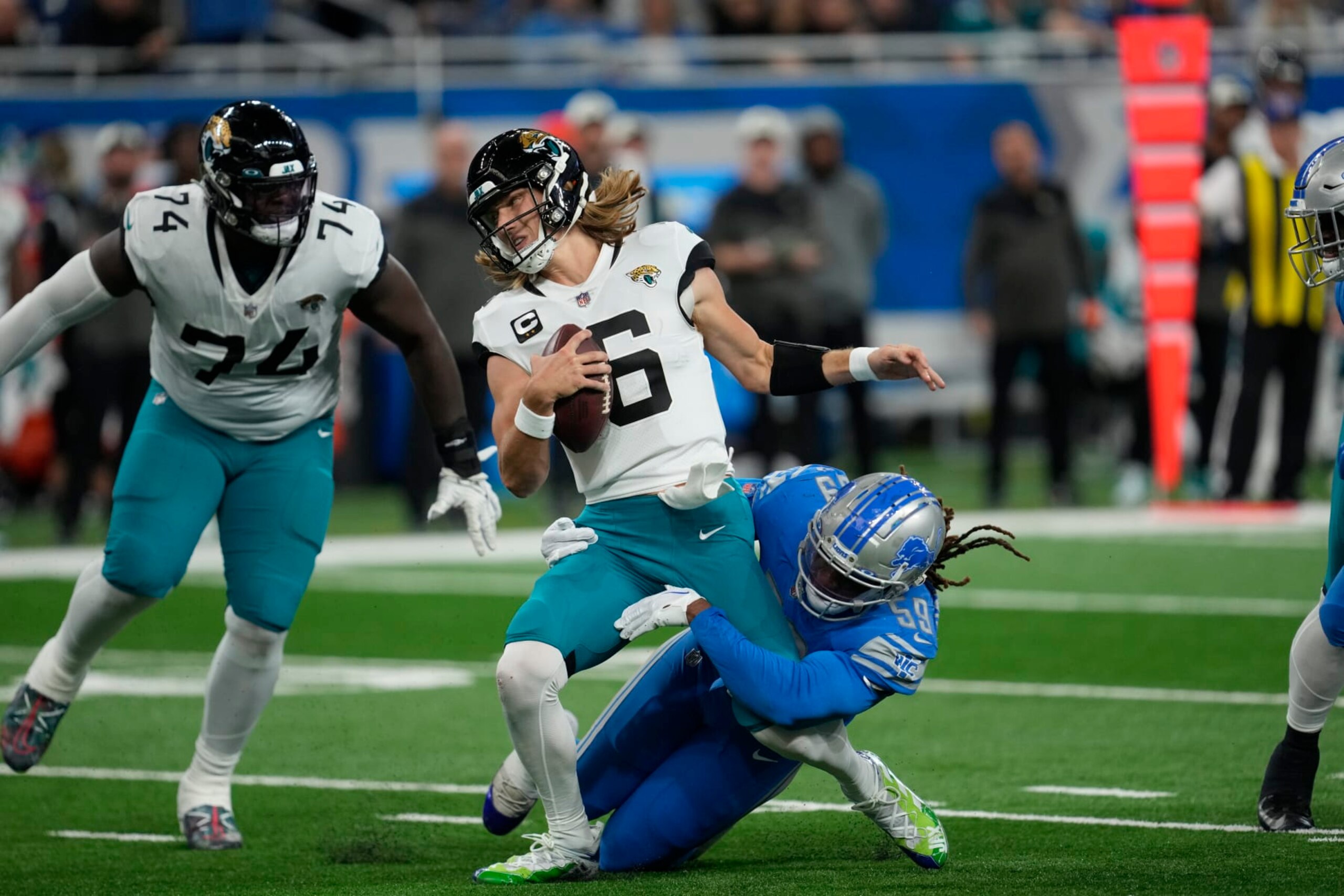 Detroit Lions linebacker James Houston (59) sacks Jacksonville Jaguars quarterback Trevor Lawrence (16) during an NFL football game in Detroit, Sunday, Dec. 4, 2022. (AP Photo/Paul Sancya) Detroit Lions linebacker James Houston (59) sacks Jacksonville Jaguars quarterback Trevor Lawrence (16) during an NFL football game in Detroit, Sunday, Dec. 4, 2022. (AP Photo/Paul Sancya)
