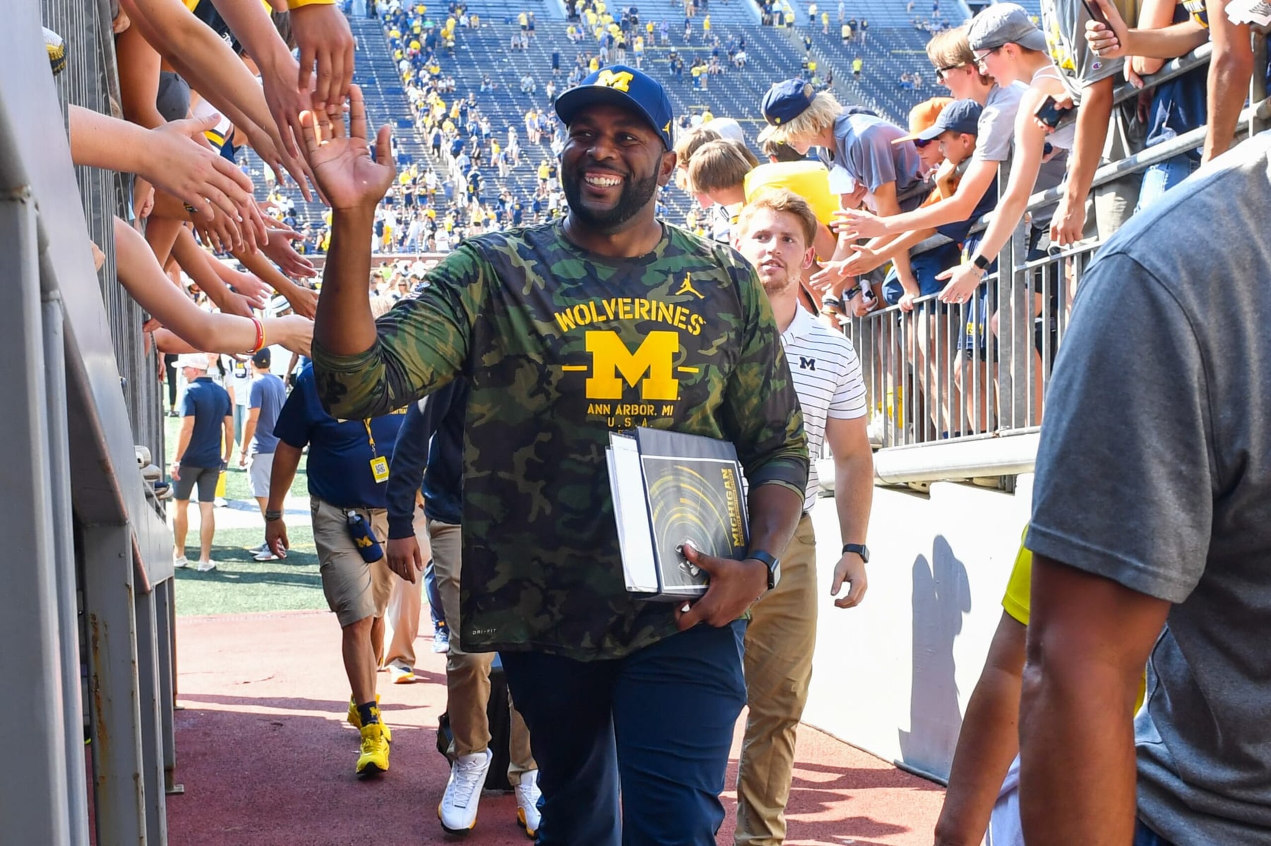 ANN ARBOR, MICHIGAN - SEPTEMBER 17:  Co-Offensive Coordinator / Assistant Coach Sherrone Moore of the Michigan Wolverines walks off the field after a college football game against the Connecticut Huskies at Michigan Stadium on September 17, 2022 in Ann Arbor, Michigan. The Michigan Wolverines won the game 59-0 over the Connecticut Huskies. (Photo by Aaron J. Thornton/Getty Images)