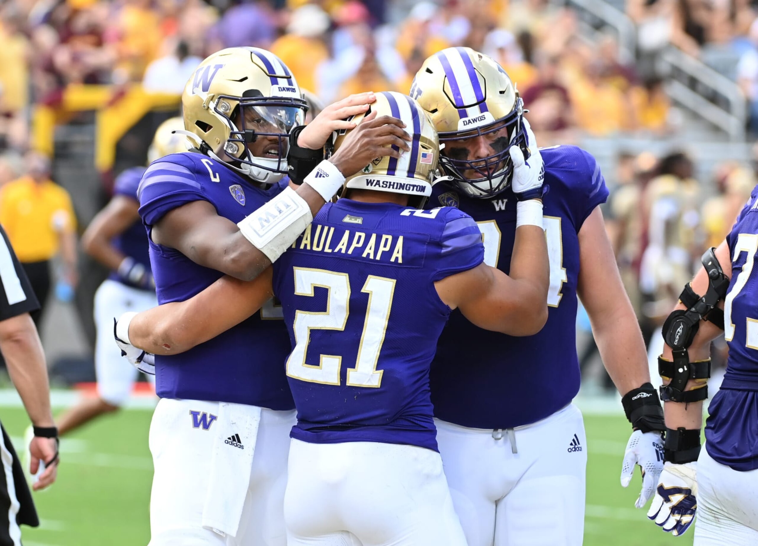 TEMPE, ARIZONA - OCTOBER 08: Wayne Taulapapa #21 of the University of Washington Huskies celebrates with Michael Penix Jr #9 and Corey Luciano #74 after scoring a rushing touchdown against the Arizona State University Sun Devils during the second quarter at Sun Devil Stadium on October 08, 2022 in Tempe, Arizona. (Photo by Norm Hall/Getty Images)