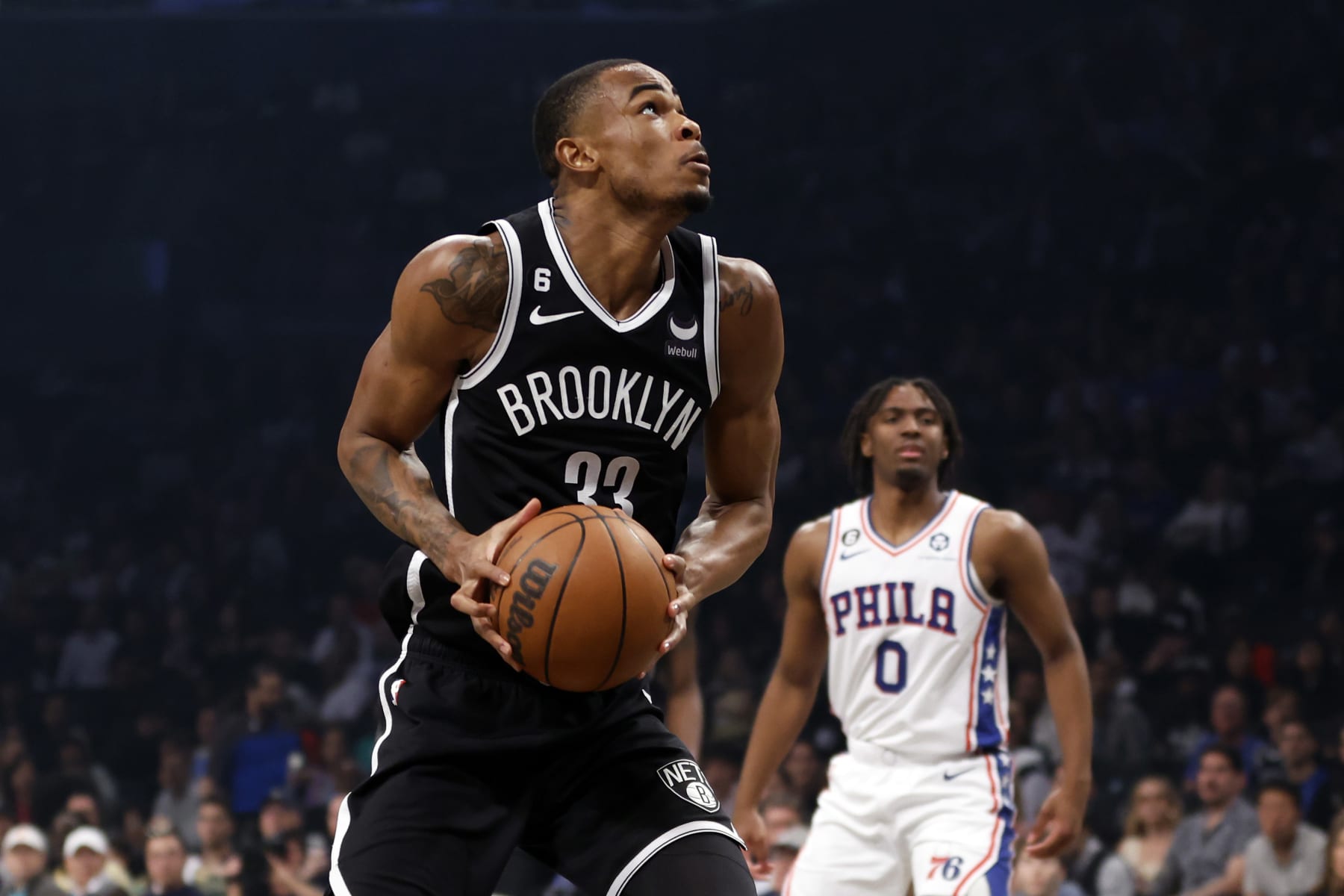 NEW YORK, NEW YORK - APRIL 22: Nic Claxton #33 of the Brooklyn Nets goes to the basket as Tyrese Maxey #0 of the Philadelphia 76ers defends during the first half of Game Four of the Eastern Conference First Round Playoffs at Barclays Center on April 22, 2023 in the Brooklyn borough of New York City. NOTE TO USER: User expressly acknowledges and agrees that, by downloading and or using this photograph, User is consenting to the terms and conditions of the Getty Images License Agreement. (Photo by Sarah Stier/Getty Images)