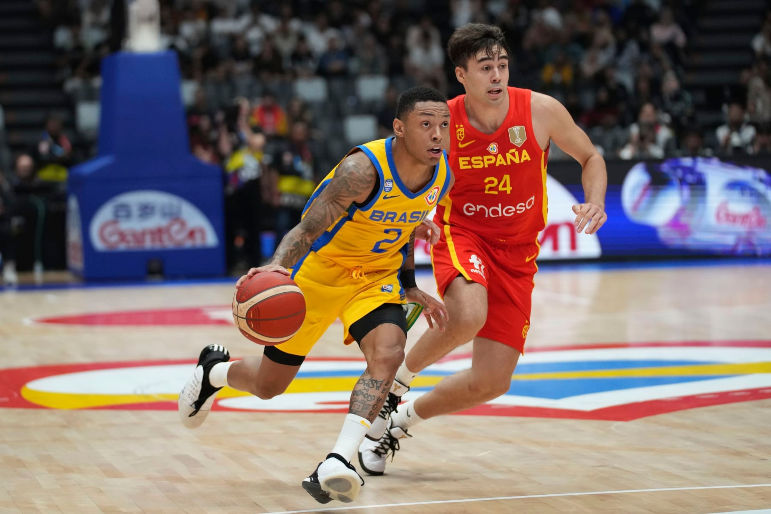 Brazil guard Yago Santos (2) dribbles the ball against Spain guard Juan Nunez (24) during the Basketball World Cup group G match between Spain and Brazil at the Indonesia Arena stadium in Jakarta, Indonesia, Monday, Aug. 28, 2023. (AP Photo/Tatan Syuflana) Brazil guard Yago Santos (2) dribbles the ball against Spain guard Juan Nunez (24) during the Basketball World Cup group G match between Spain and Brazil at the Indonesia Arena stadium in Jakarta, Indonesia, Monday, Aug. 28, 2023. (AP Photo/Tatan Syuflana)