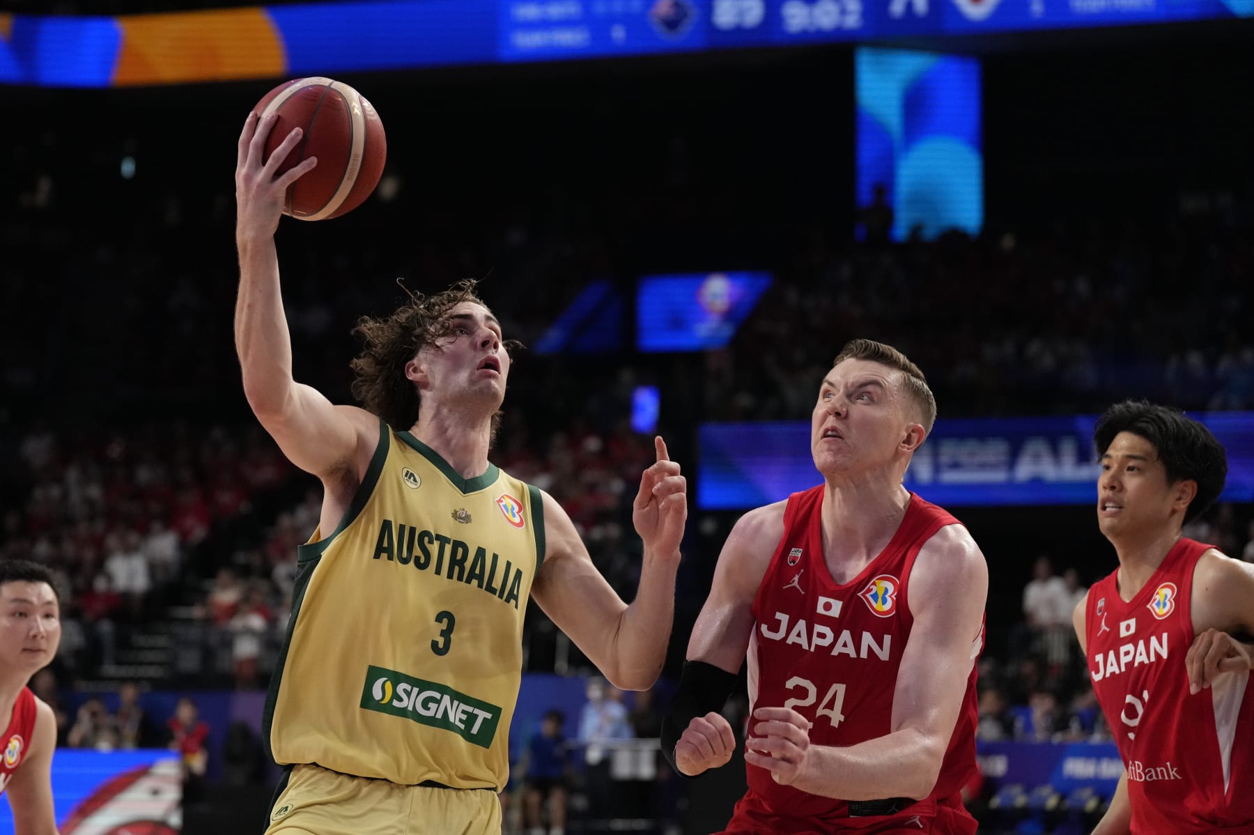 Australia guard Josh Giddey (3) tries to shoot against Japan center Josh Hawkinson (24) in the second half of their Basketball World Cup group E match in Okinawa, southern Japan, Tuesday, Aug. 29, 2023. (AP Photo/Hiro Komae)