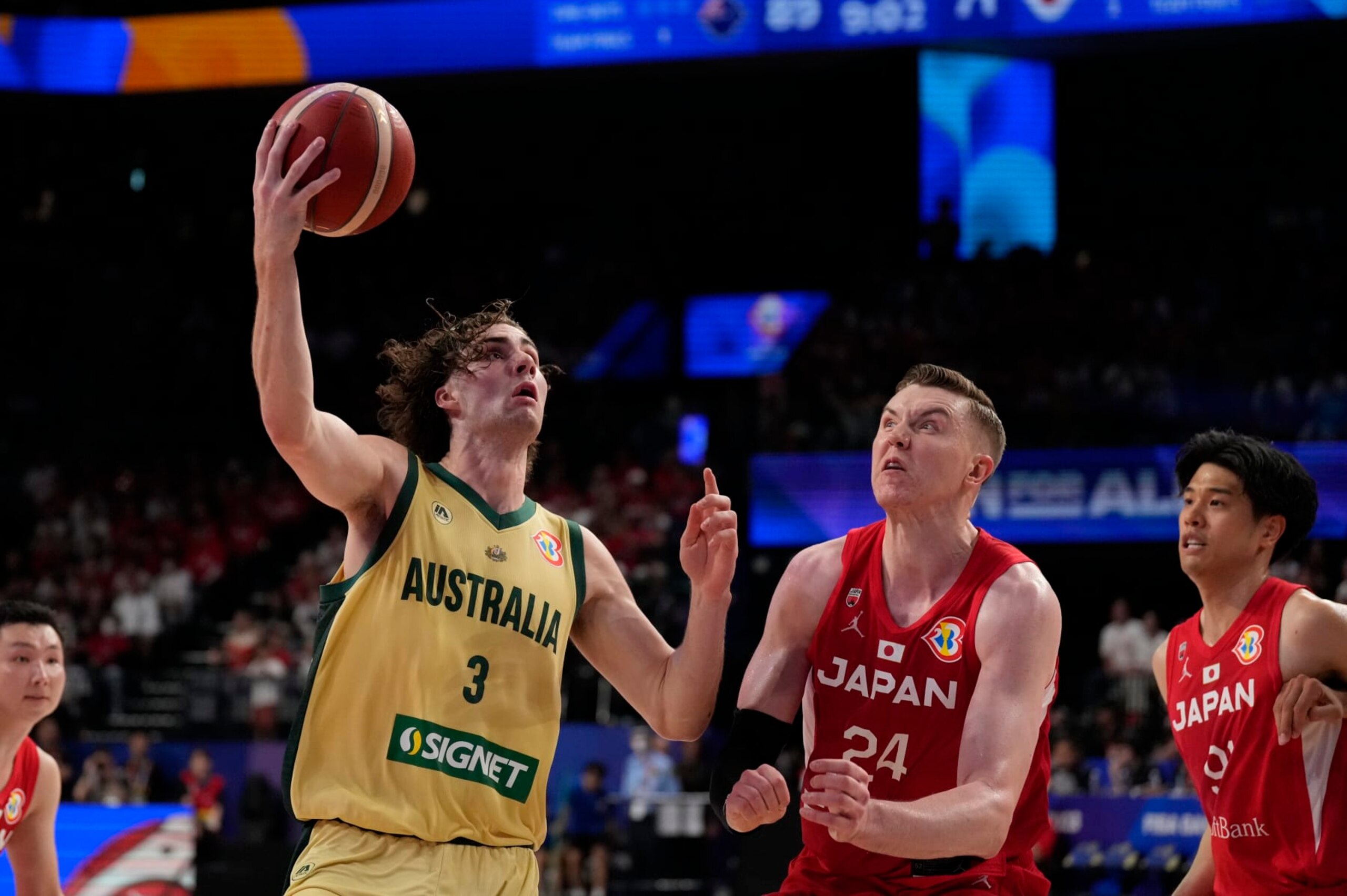 Australia guard Josh Giddey (3) tries to shoot against Japan center Josh Hawkinson (24) in the second half of their Basketball World Cup group E match in Okinawa, southern Japan, Tuesday, Aug. 29, 2023. (AP Photo/Hiro Komae)