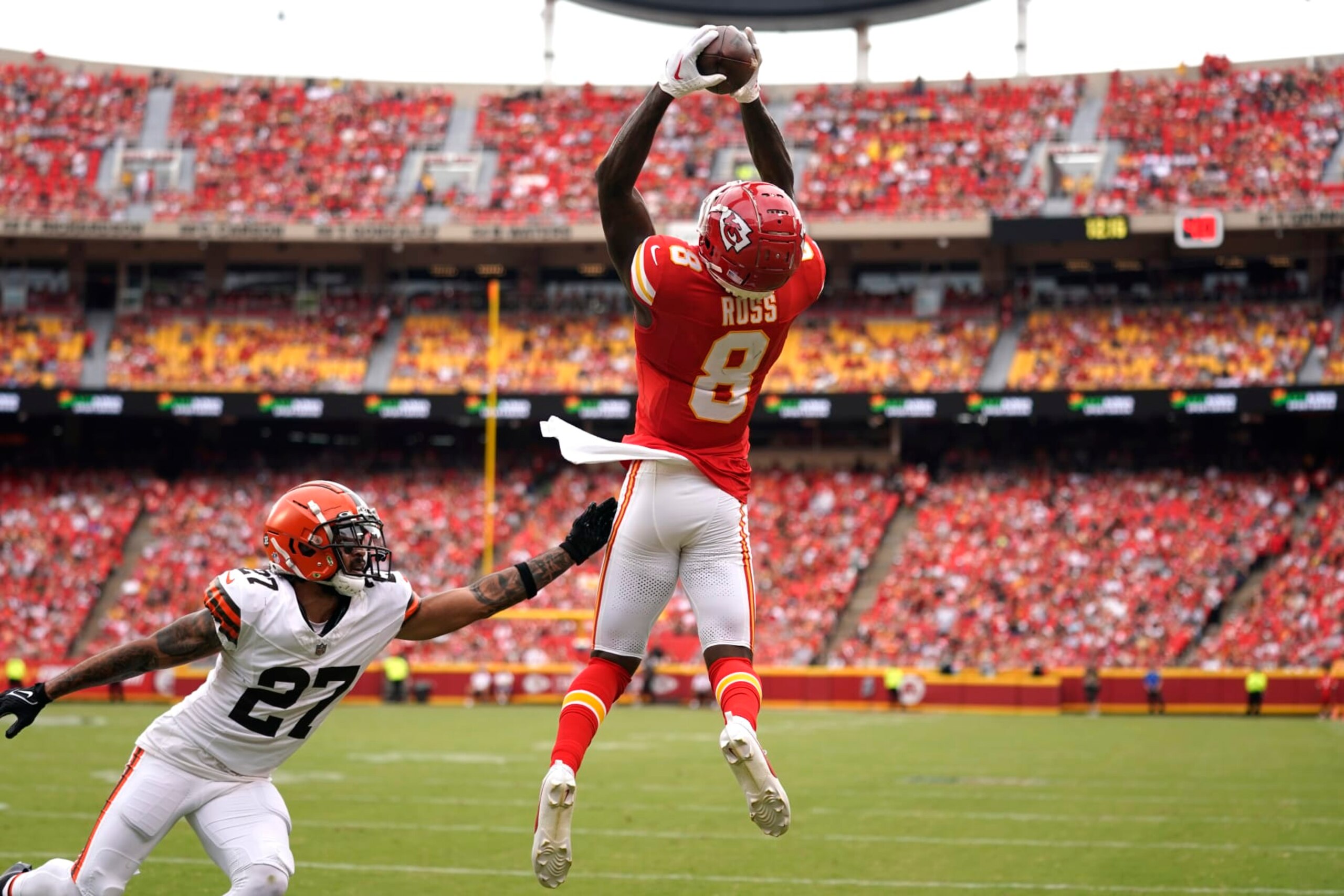 Kansas City Chiefs wide receiver Justyn Ross (8) catches a touchdown pass against Cleveland Browns cornerback Lorenzo Burns (27) during an NFL preseason football game Saturday, Aug. 26, 2023, in Kansas City, Mo. (AP Photo/Ed Zurga)