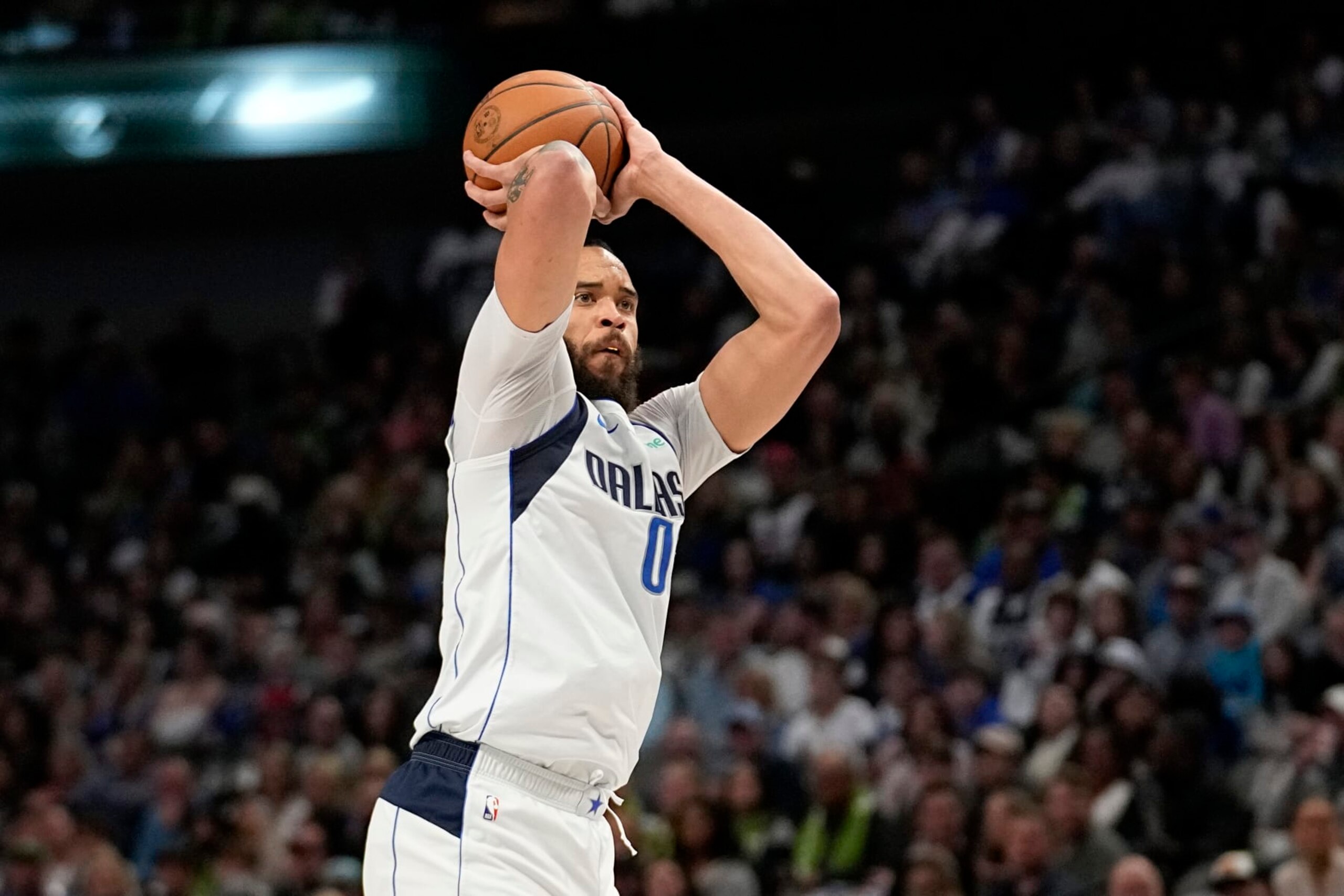 Dallas Mavericks center JaVale McGee prepares to shoot a 3-point basket in the first half of an NBA basketball game against the Chicago Bulls, Friday, April 7, 2023, in Dallas. (AP Photo/Tony Gutierrez)