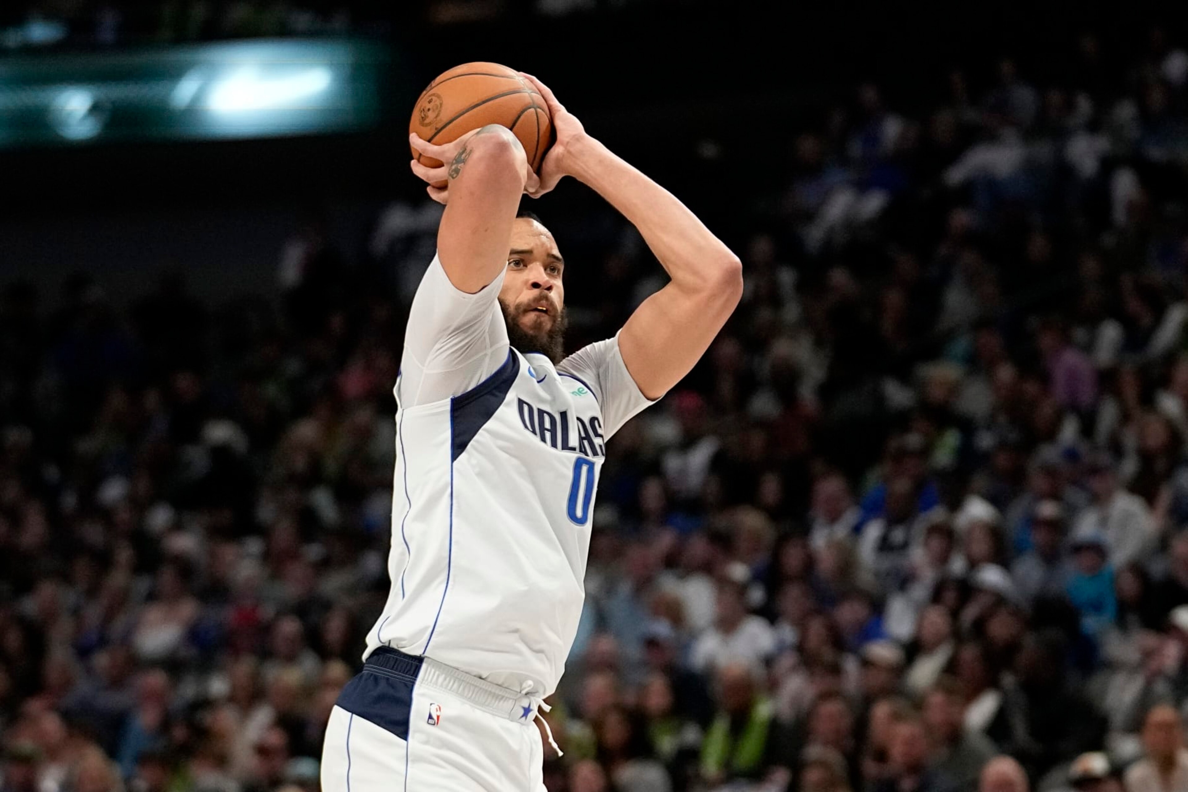 Dallas Mavericks center JaVale McGee prepares to shoot a 3-point basket in the first half of an NBA basketball game against the Chicago Bulls, Friday, April 7, 2023, in Dallas. (AP Photo/Tony Gutierrez)