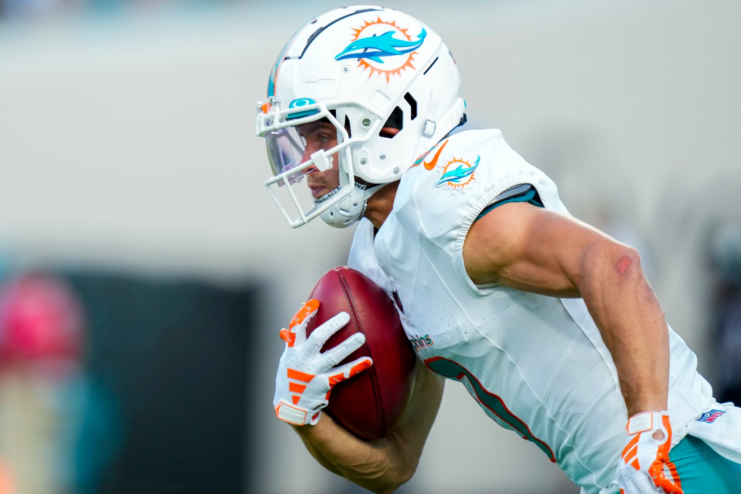 JACKSONVILLE, FLORIDA - AUGUST 26: Braxton Berrios #0 of the Miami Dolphins returns the punt against the Jacksonville Jaguars during the first quarter of a preseason game at TIAA Bank Field on August 26, 2023 in Jacksonville, Florida. (Photo by Rich Storry/Getty Images)