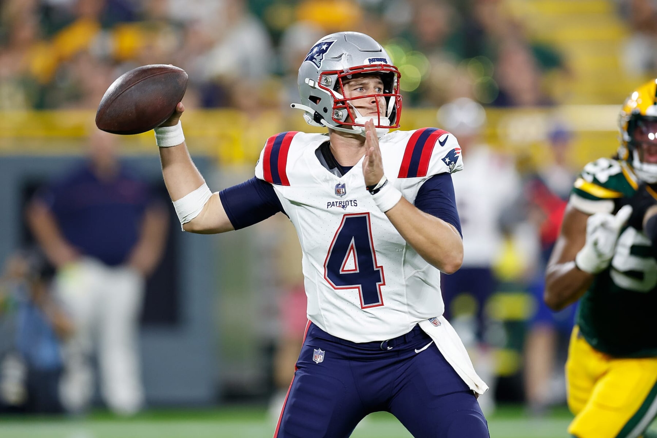 GREEN BAY, WISCONSIN - AUGUST 19: Bailey Zappe #4 of the New England Patriots throws a pass in the 3rd quarter against the Green Bay Packers during a preseason game at Lambeau Field on August 19, 2023 in Green Bay, Wisconsin. (Photo by John Fisher/Getty Images)