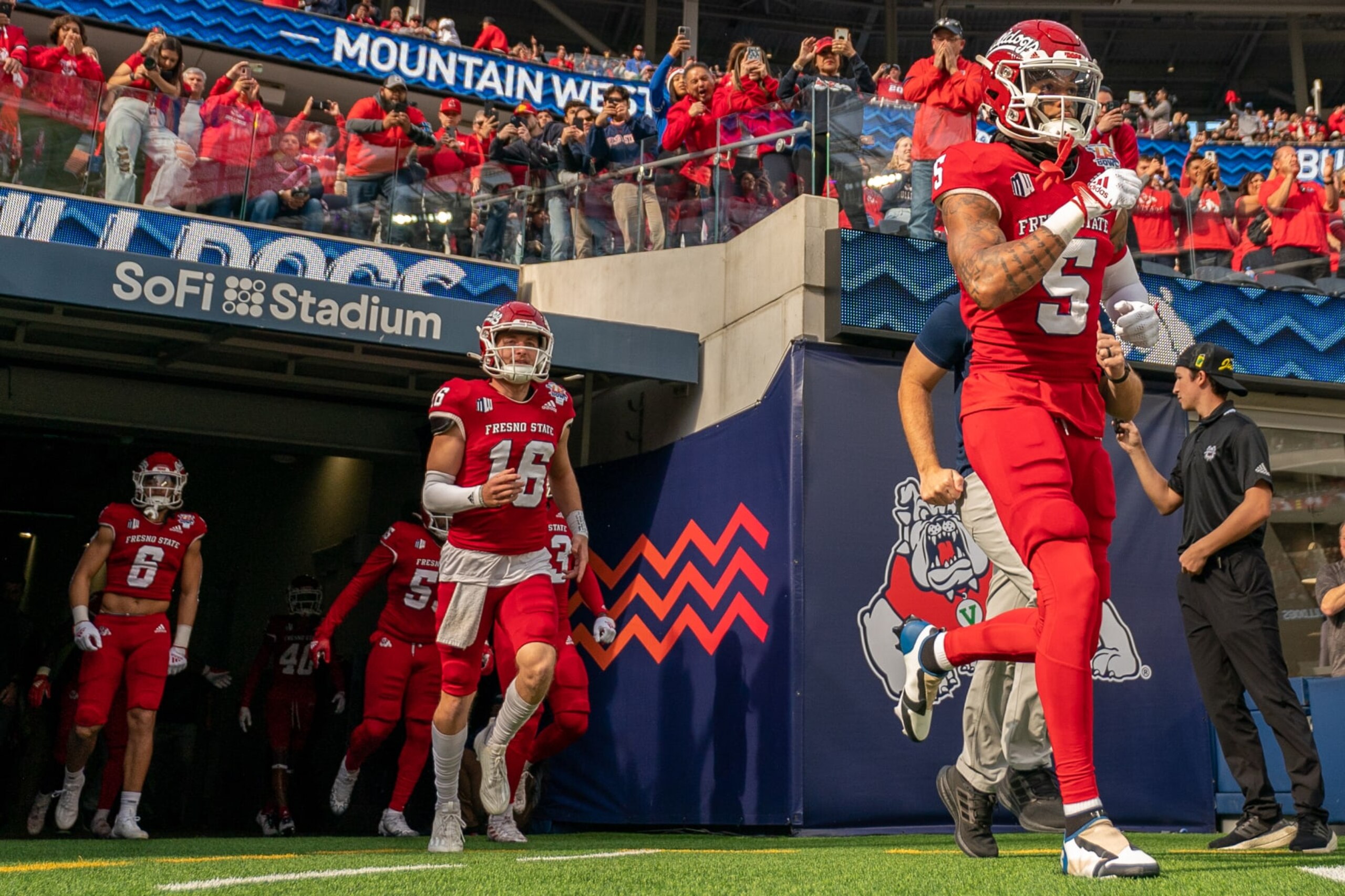 LOS ANGELS, CA - DECEMBER 17: Devo Bridges #5 and Alec Trujillo #16 of Fresno State run out of the tunnel at the beginning of the LA Bowl game between Washington State Cougars and Fresno State Bulldogs at SoFi Stadium on December 17, 2022 in Los Angels, California. (Photo by Jason Allen/ISI Photos/Getty Images)