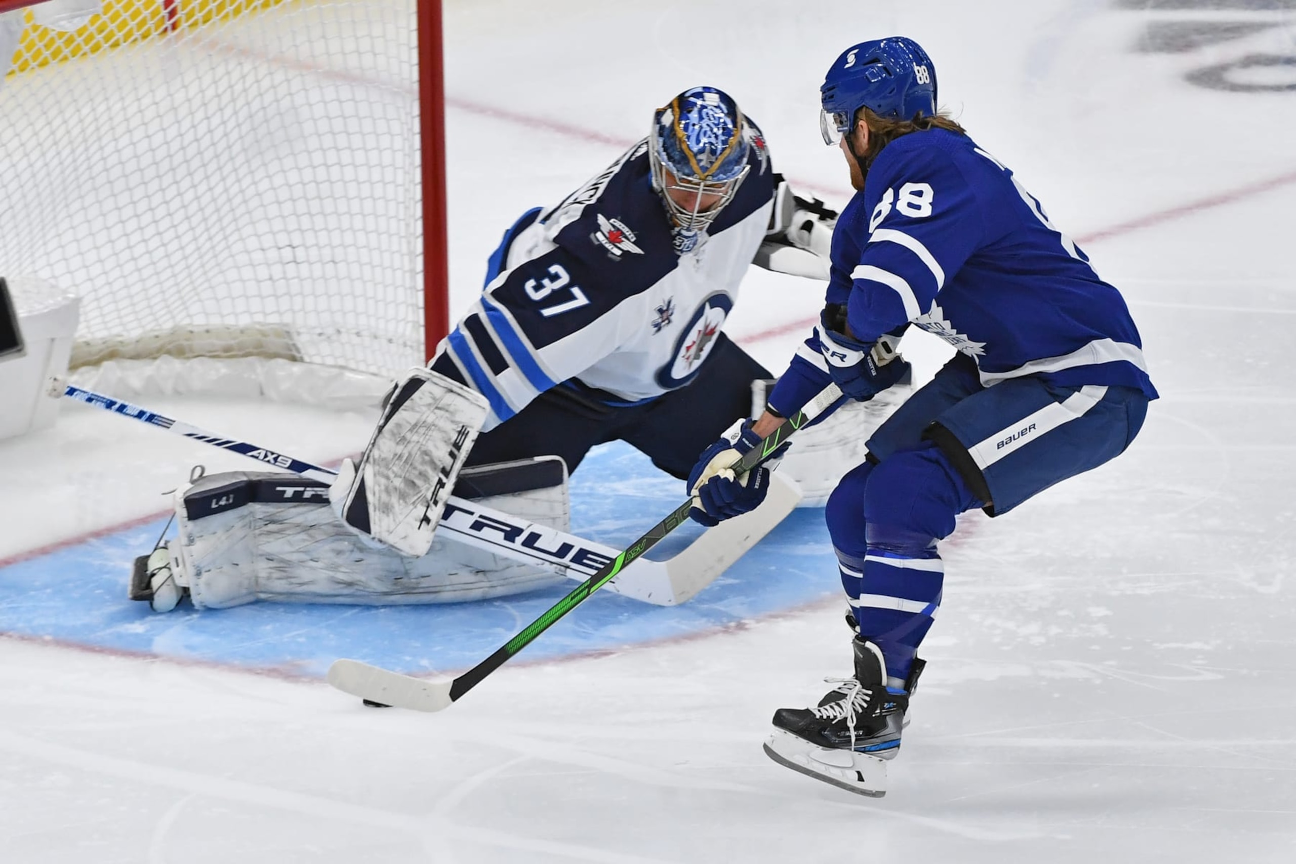 Winnipeg Jets goaltender Connor Hellebuyck and Toronto Maple Leafs winger William Nylander Winnipeg Jets goaltender Connor Hellebuyck and Toronto Maple Leafs winger William Nylander