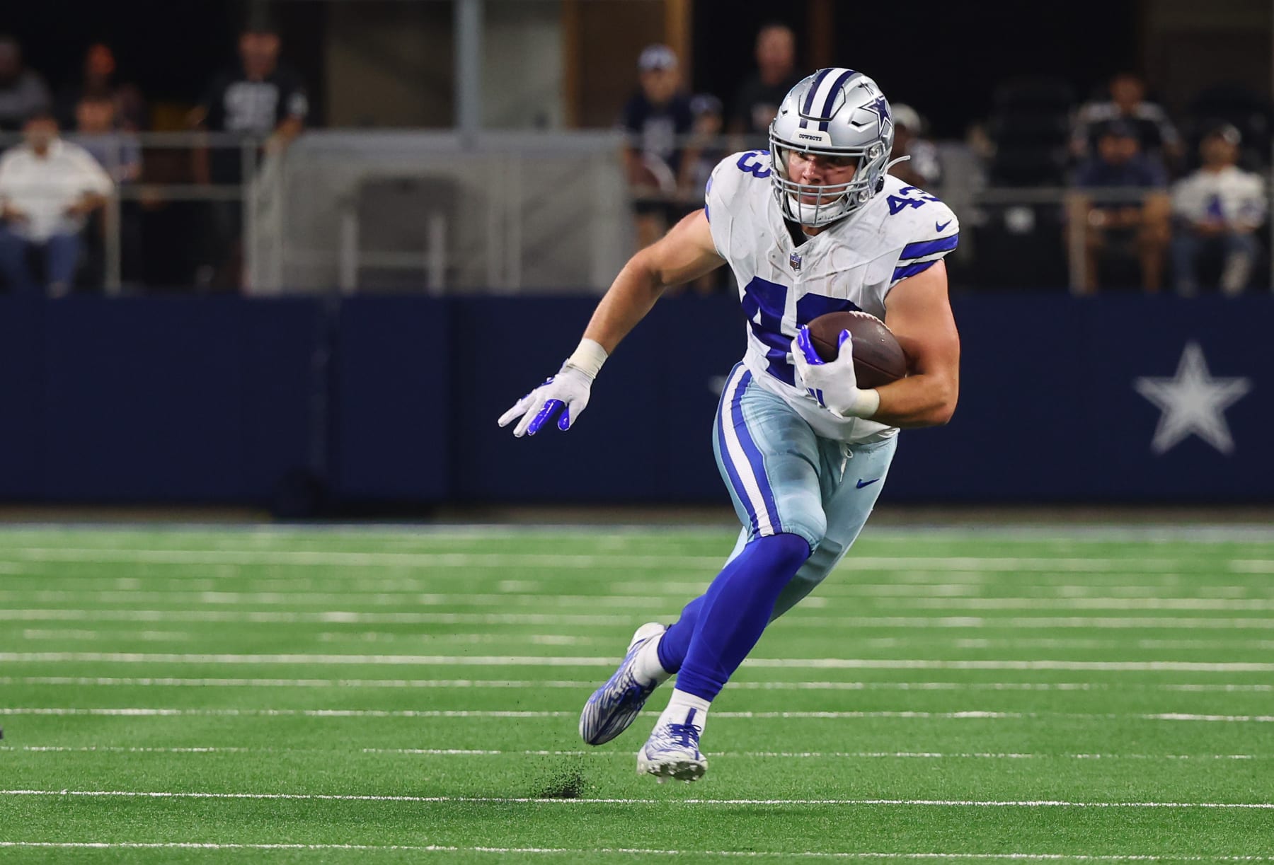 ARLINGTON, TEXAS - AUGUST 26: Hunter Luepke #43 of the Dallas Cowboys carries the football in the second quarter against the Las Vegas Raiders in a preseason game at AT&T Stadium on August 26, 2023 in Arlington, Texas. (Photo by Richard Rodriguez/Getty Images)