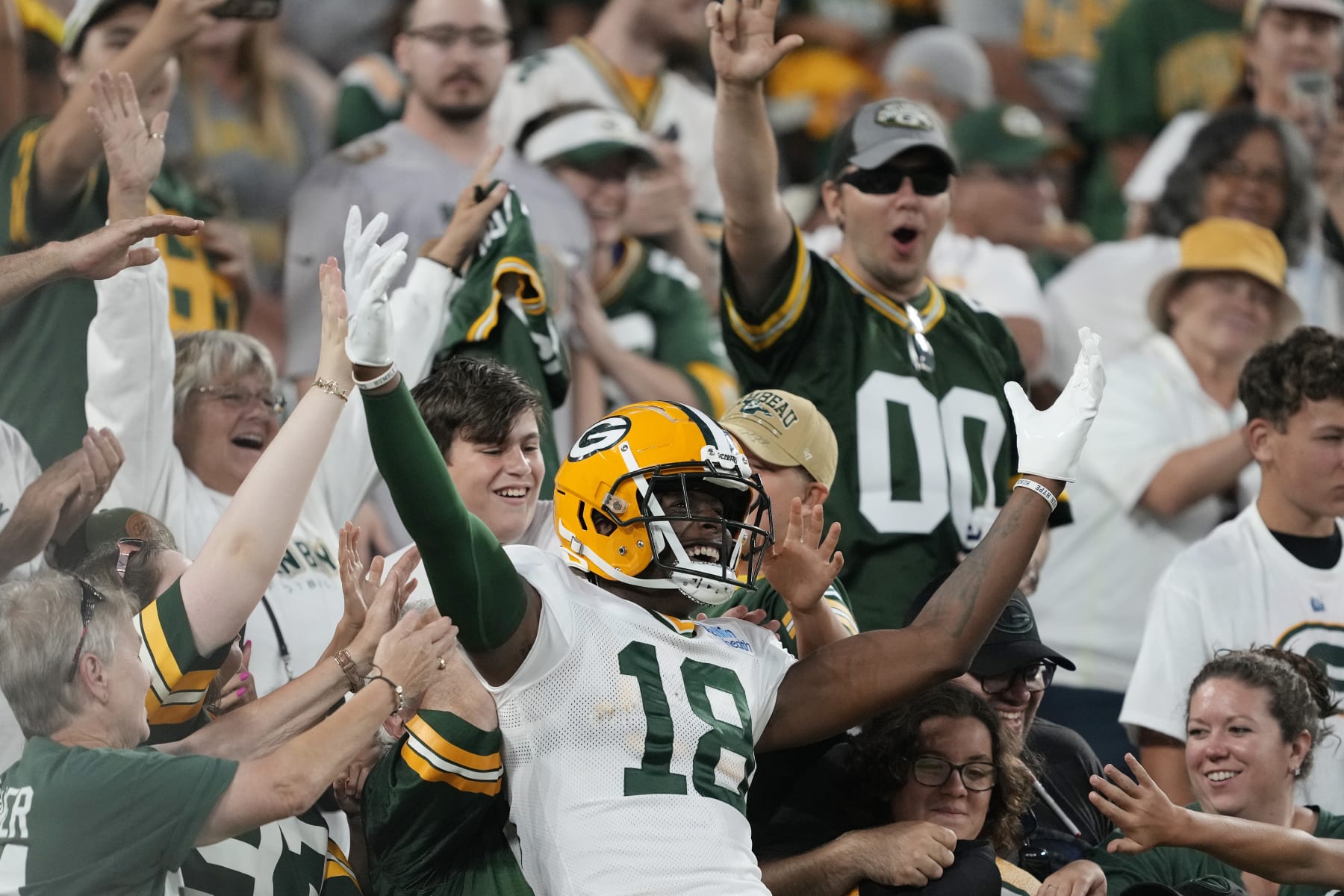 GREEN BAY, WISCONSIN - AUGUST 05: Malik Heath #18 of the Green Bay Packers celebrates with fans during Packers Family Night at Lambeau Field on August 05, 2023 in Green Bay, Wisconsin. (Photo by Patrick McDermott/Getty Images)