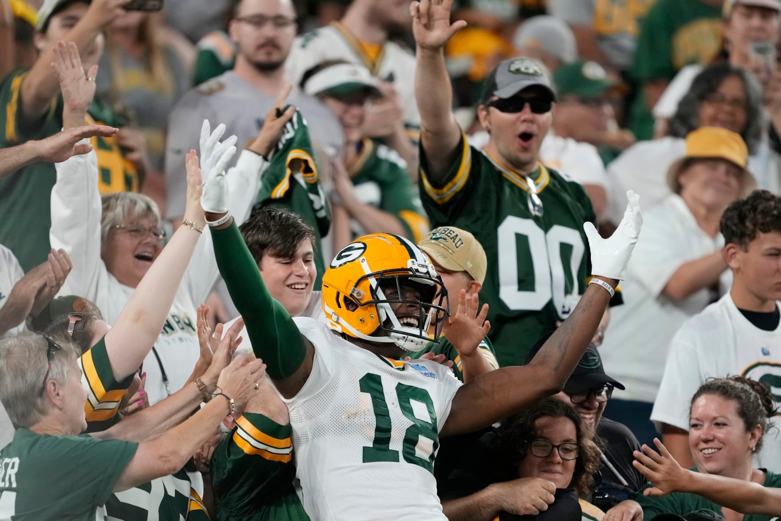 GREEN BAY, WISCONSIN - AUGUST 05: Malik Heath #18 of the Green Bay Packers celebrates with fans during Packers Family Night at Lambeau Field on August 05, 2023 in Green Bay, Wisconsin. (Photo by Patrick McDermott/Getty Images)