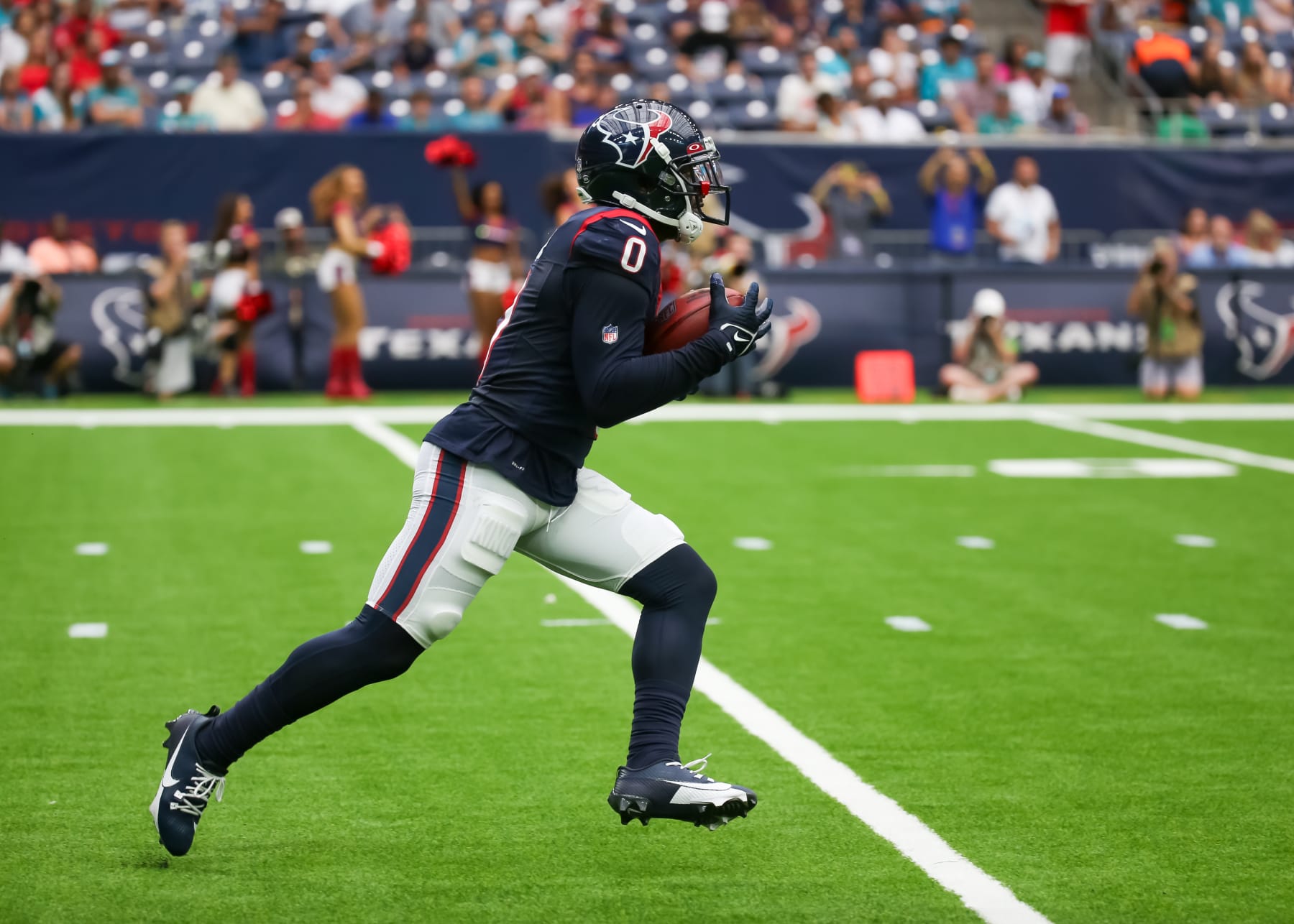 HOUSTON, TX - AUGUST 19:  Houston Texans cornerback Desmond King II (0) returns the punt in the first quarter during the preseason NFL game between the Miami Dolphins and Houston Texans on August 19, 2023 at NRG Stadium in Houston, Texas.  (Photo by Leslie Plaza Johnson/Icon Sportswire via Getty Images)