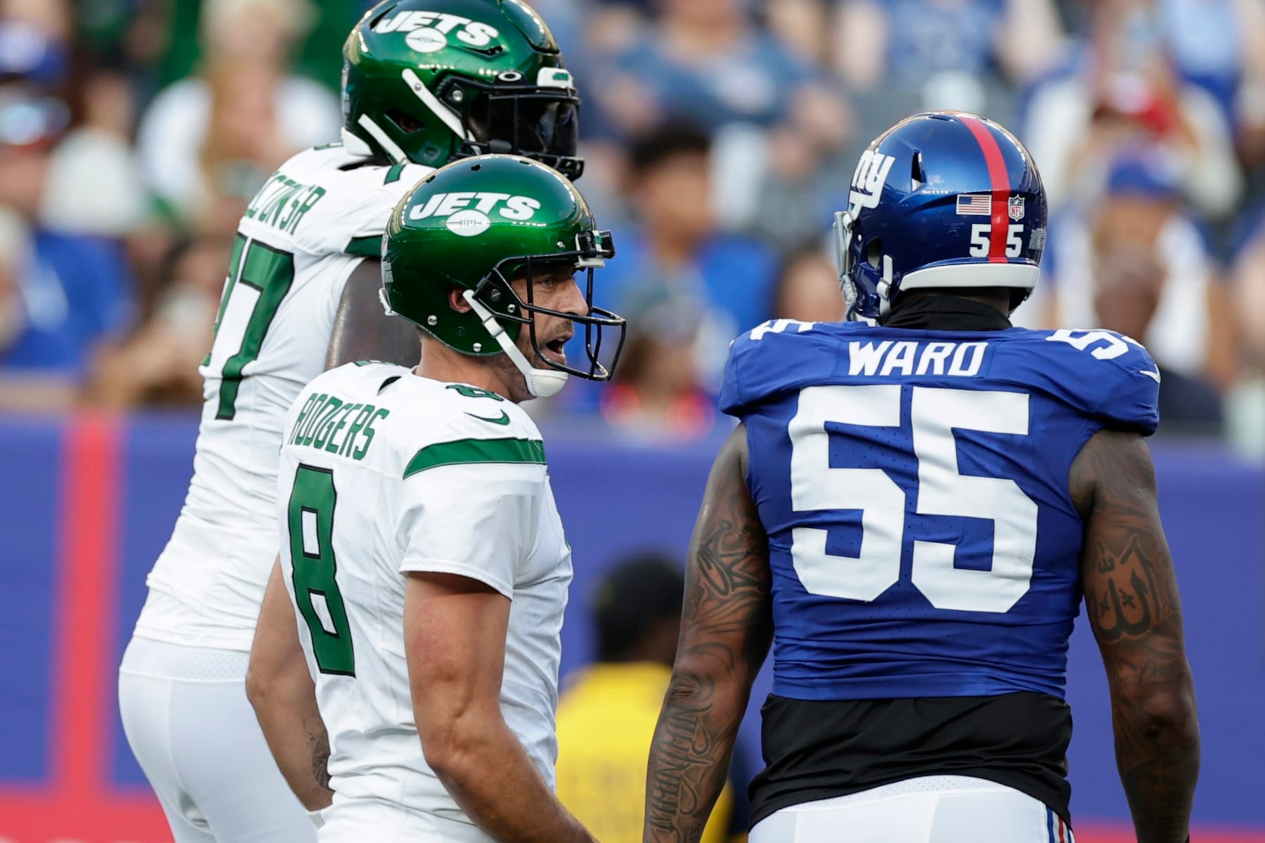 New York Jets quarterback Aaron Rodgers (8) and New York Giants linebacker Jihad Ward (55) exchange words during the first half of an NFL preseason football game, Saturday, Aug. 26, 2023, in East Rutherford, N.J. (AP Photo/Adam Hunger) New York Jets quarterback Aaron Rodgers (8) and New York Giants linebacker Jihad Ward (55) exchange words during the first half of an NFL preseason football game, Saturday, Aug. 26, 2023, in East Rutherford, N.J. (AP Photo/Adam Hunger)