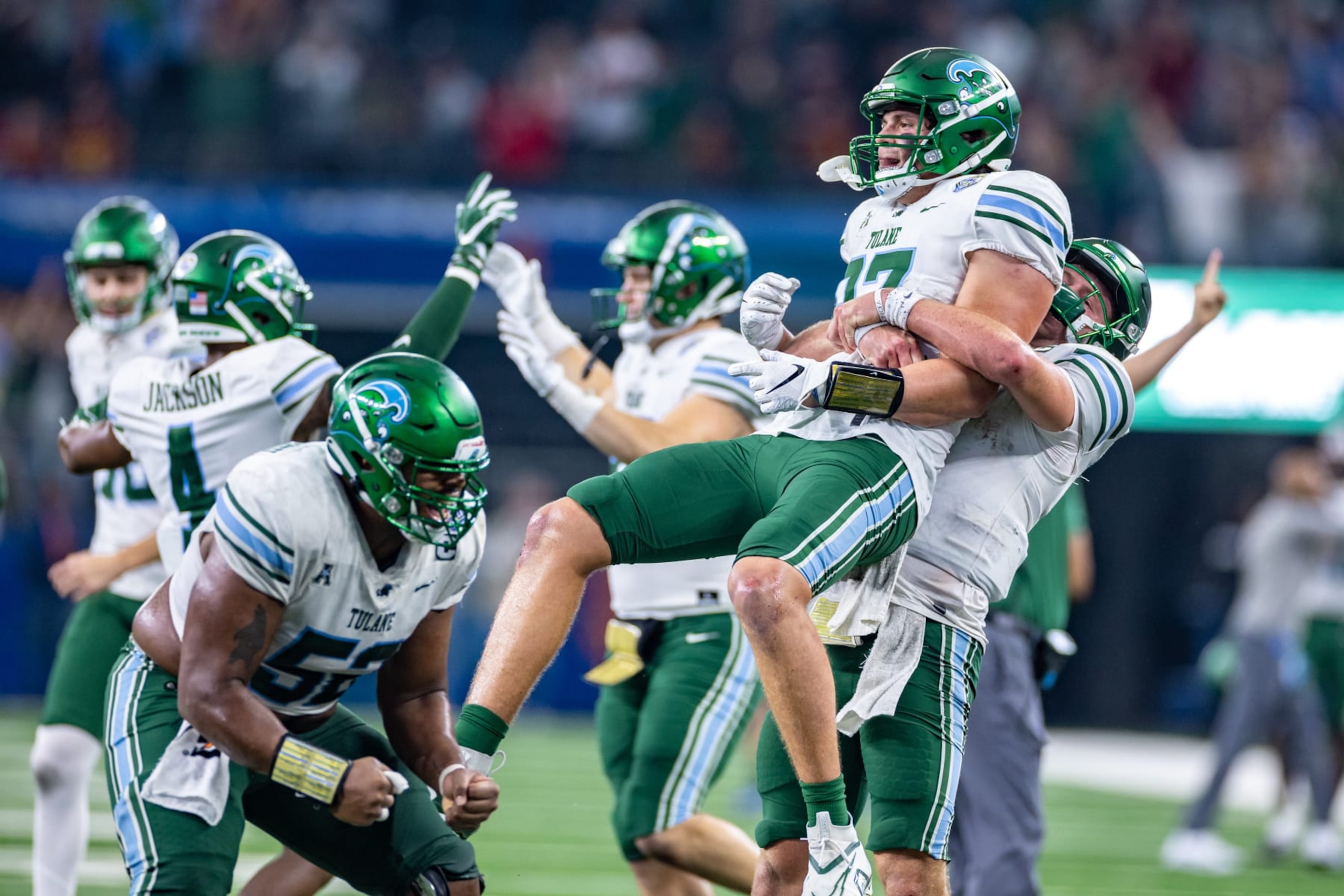 ARLINGTON, TX - JANUARY 02: Tulane Green Wave tight end Alex Bauman (#87) is lifted in the air by quarterback Michael Pratt (#7) after scoring the game winning touchdown during the Goodyear Cotton Bowl game between the USC Trojans and Tulane Green Wave on January 02, 2023 at AT&T Stadium in Arlington, TX.  (Photo by Matthew Visinsky/Icon Sportswire via Getty Images)