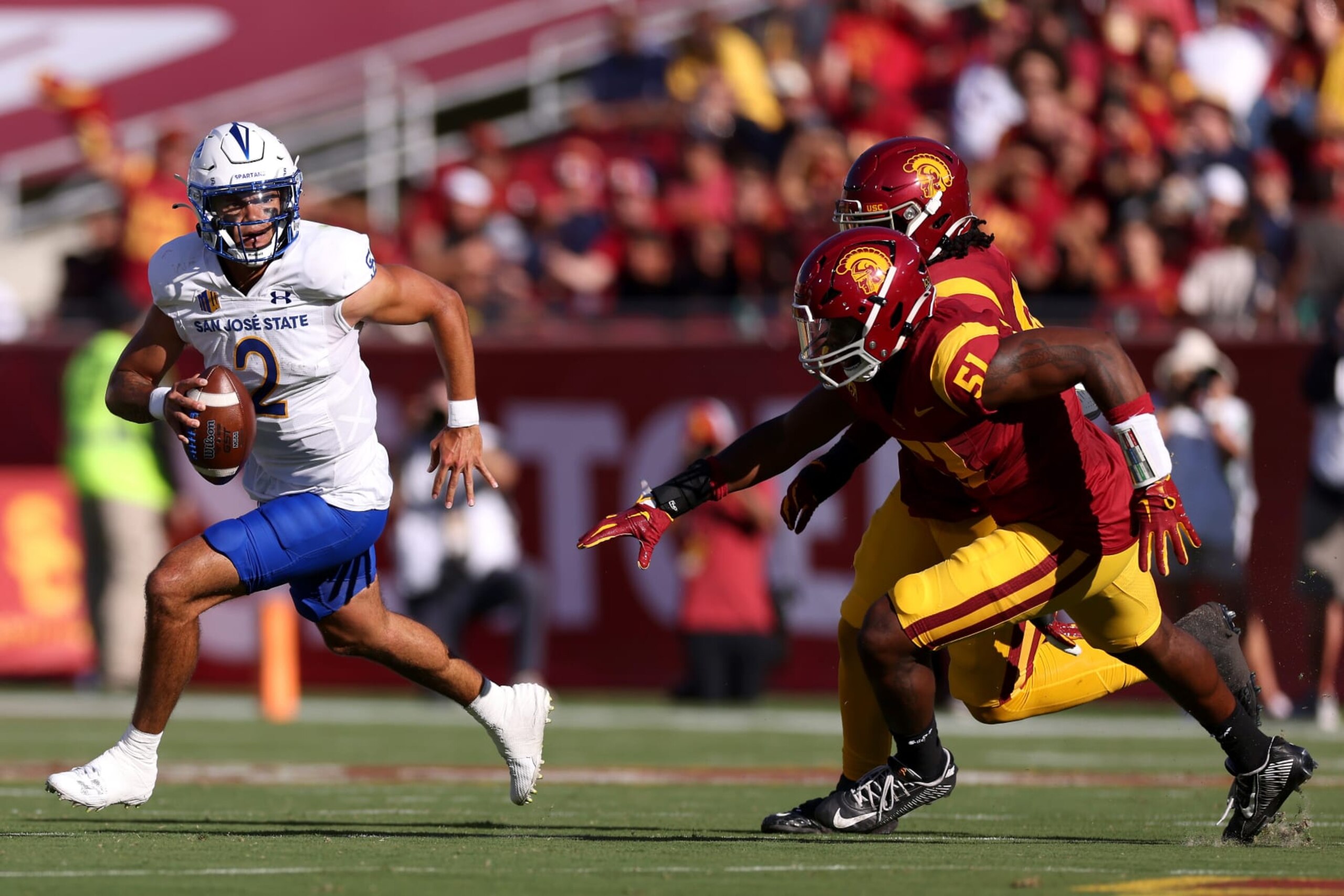 LOS ANGELES, CALIFORNIA - AUGUST 26: Chevan Cordeiro #2 of the San Jose State Spartans runs the ball against Solomon Byrd #51 of the USC Trojans during the first quarter at United Airlines Field at the Los Angeles Memorial Coliseum on August 26, 2023 in Los Angeles, California. (Photo by Katelyn Mulcahy/Getty Images)