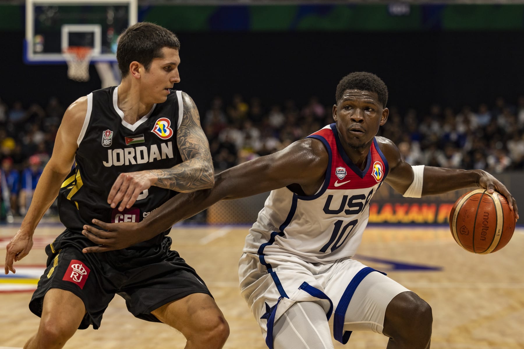 MANILA, PHILIPPINES - AUGUST 30: Anthony Edwards #10 of USA drives to the basket against Sami Bzai #9 of Jordan during the FIBA Basketball World Cup Group C game between United States and Jordan at Mall of Asia Arena on August 30, 2023 in Pasay, Metro Manila, Philippines. (Photo by Ezra Acayan/Getty Images)