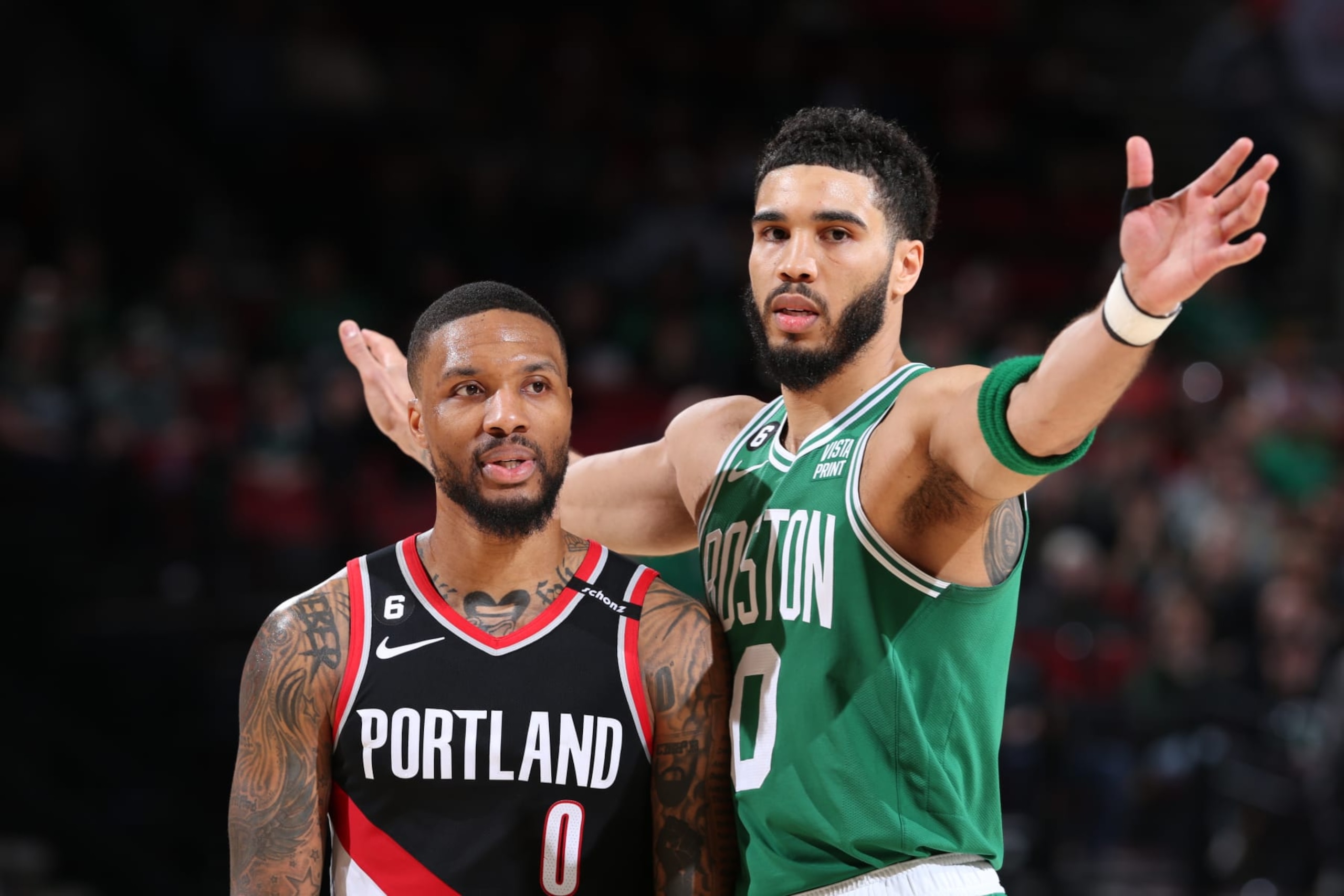 PORTLAND, OR - MARCH 17: Damian Lillard #0 of the Portland Trail Blazers and Jayson Tatum #0 of the Boston Celtics looks on during the game on March 17, 2023 at the Moda Center Arena in Portland, Oregon. NOTE TO USER: User expressly acknowledges and agrees that, by downloading and or using this photograph, user is consenting to the terms and conditions of the Getty Images License Agreement. Mandatory Copyright Notice: Copyright 2023 NBAE (Photo by Sam Forencich/NBAE via Getty Images) PORTLAND, OR - MARCH 17: Damian Lillard #0 of the Portland Trail Blazers and Jayson Tatum #0 of the Boston Celtics looks on during the game on March 17, 2023 at the Moda Center Arena in Portland, Oregon. NOTE TO USER: User expressly acknowledges and agrees that, by downloading and or using this photograph, user is consenting to the terms and conditions of the Getty Images License Agreement. Mandatory Copyright Notice: Copyright 2023 NBAE (Photo by Sam Forencich/NBAE via Getty Images)