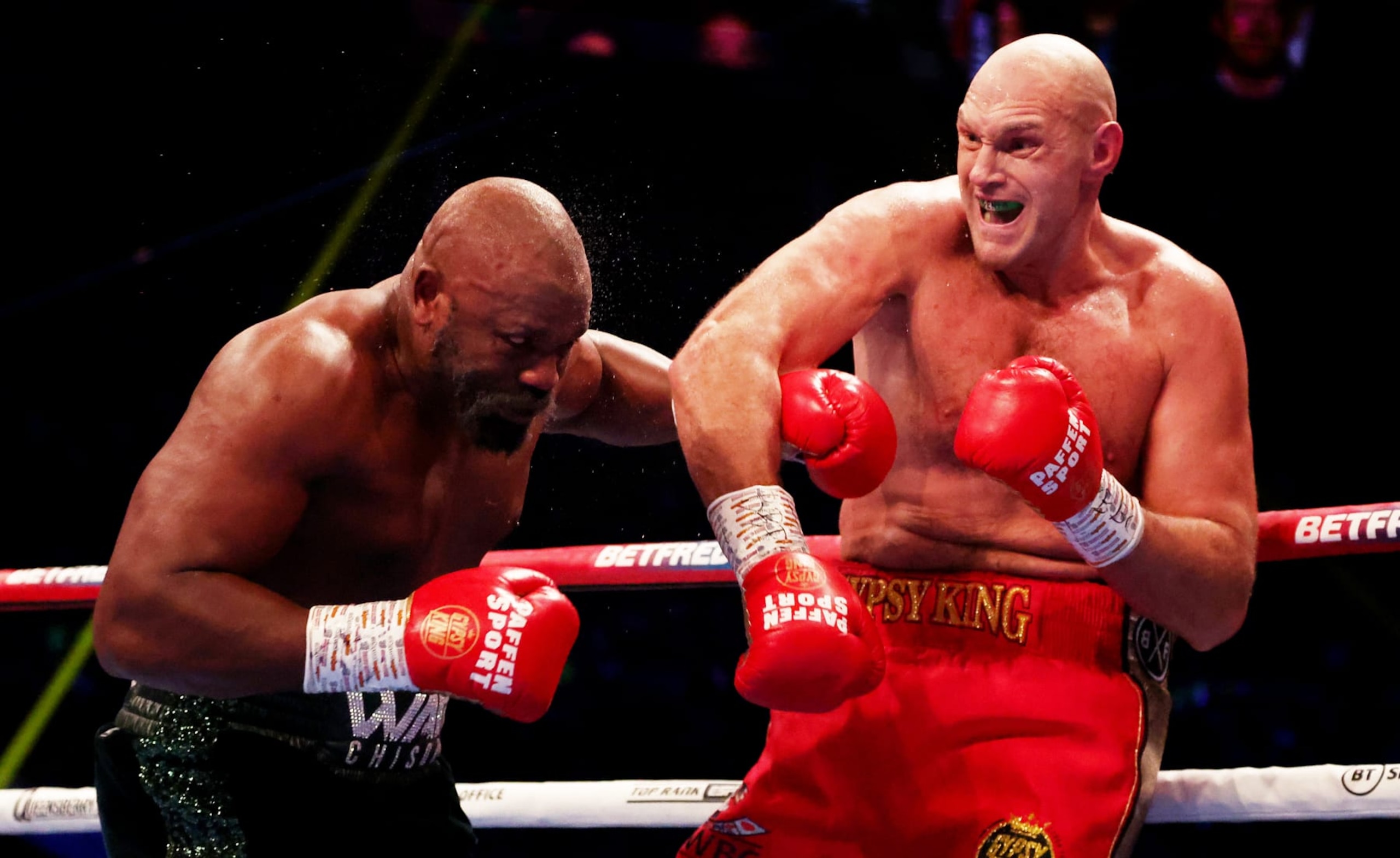 LONDON, ENGLAND - DECEMBER 03: Tyson Fury (R) punches  Derek Chisora (L) during the WBC World Heavyweight Title fight between Tyson Fury and Derek Chisora at Tottenham Hotspur Stadium on December 03, 2022 in London, England. (Photo by Warren Little/Getty Images)