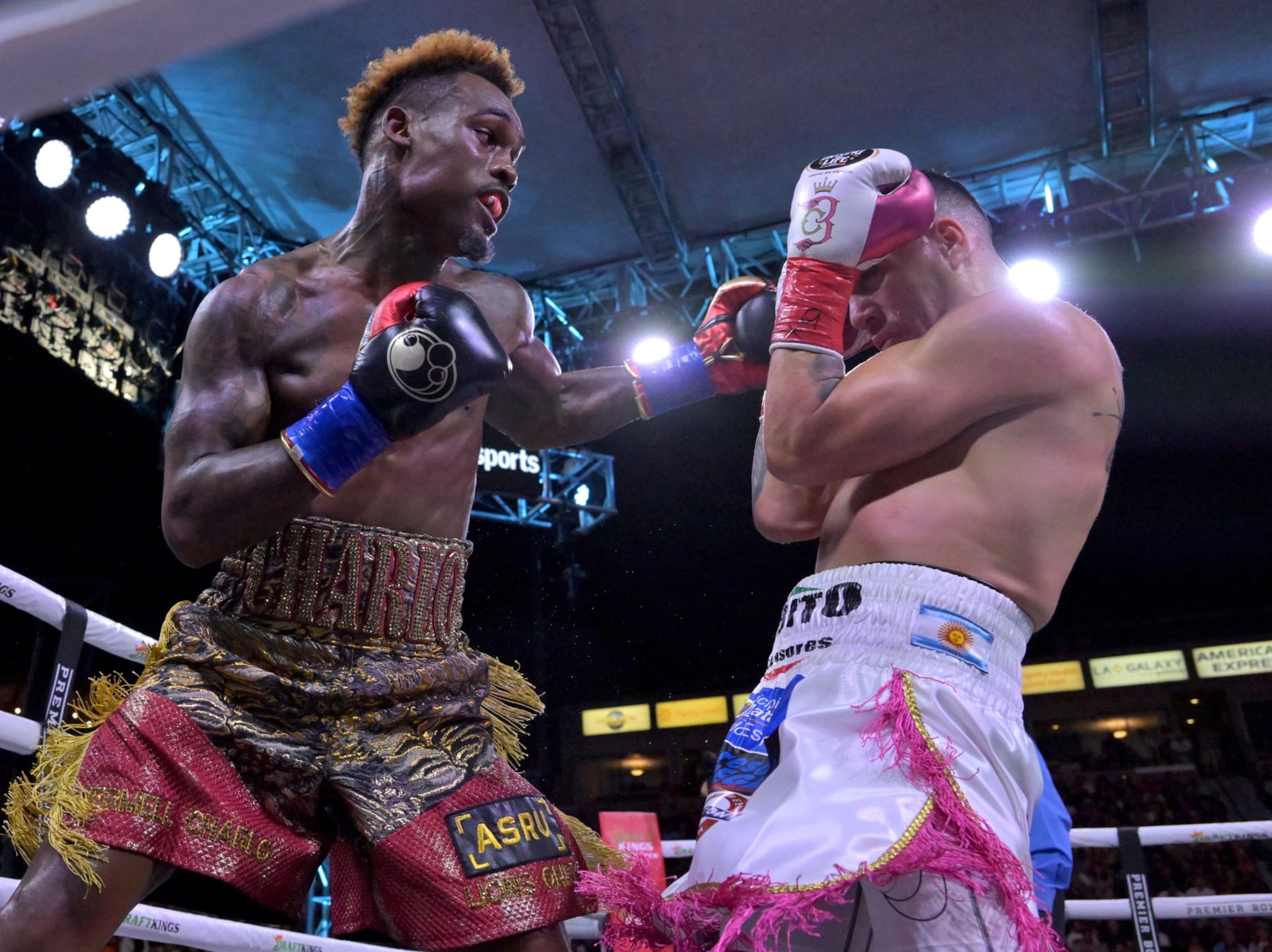 CARSON, CA - MAY 14: Jermell Charlo (gold/red shorts) exchanges punches in the ring with Brian Castano (white/pink shorts) during their super middleweight title fight at Dignity Health Sports Park on May 14, 2022 in Carson, California. Charlo won by knockout in the 10th round. (Photo by Jayne Kamin-Oncea/Getty Images)