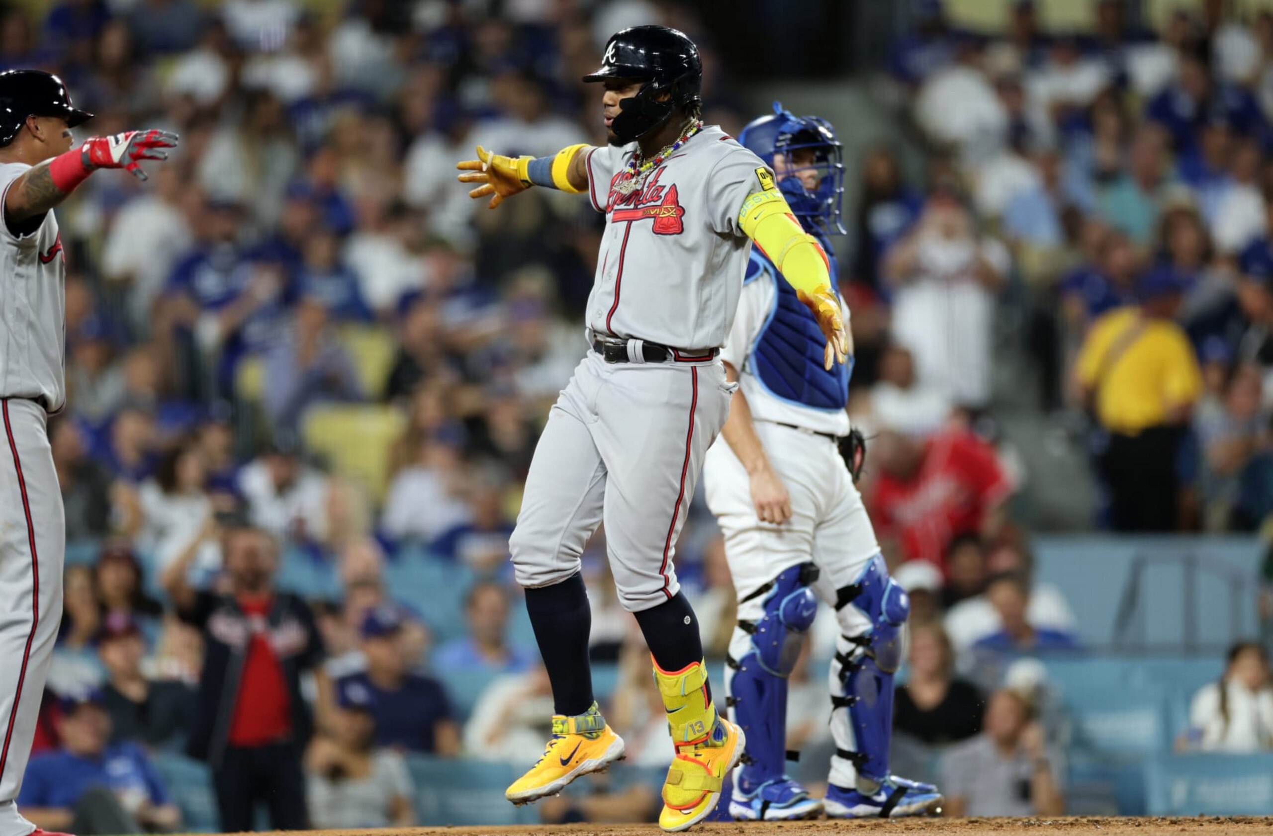 LOS ANGELES, CALIFORNIA - AUGUST 31: Ronald Acuna Jr. #13 of the Atlanta Braves celebrates his grand slam home run with Orlando Arcia #11 as catcher Will Smith #16 of the Los Angeles Dodgers looks on during the second inning at Dodger Stadium on August 31, 2023 in Los Angeles, California. (Photo by Kevork Djansezian/Getty Images)