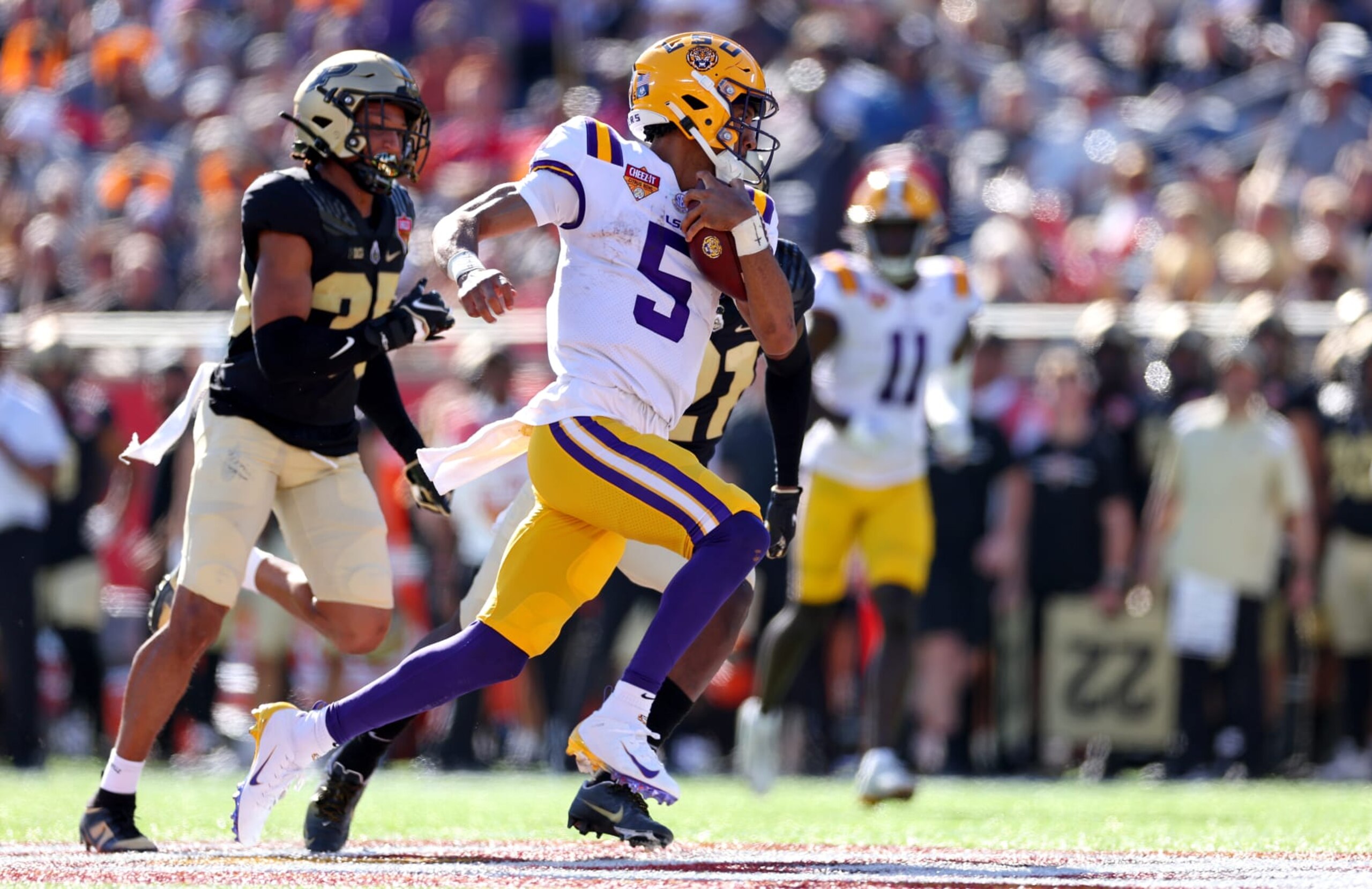 ORLANDO, FLORIDA - JANUARY 02: Jayden Daniels #5 of the LSU Tigers scrambles during the Cheez-It Citrus Bowl against the Purdue Boilermakers at Camping World Stadium on January 02, 2023 in Orlando, Florida. (Photo by Mike Ehrmann/Getty Images)