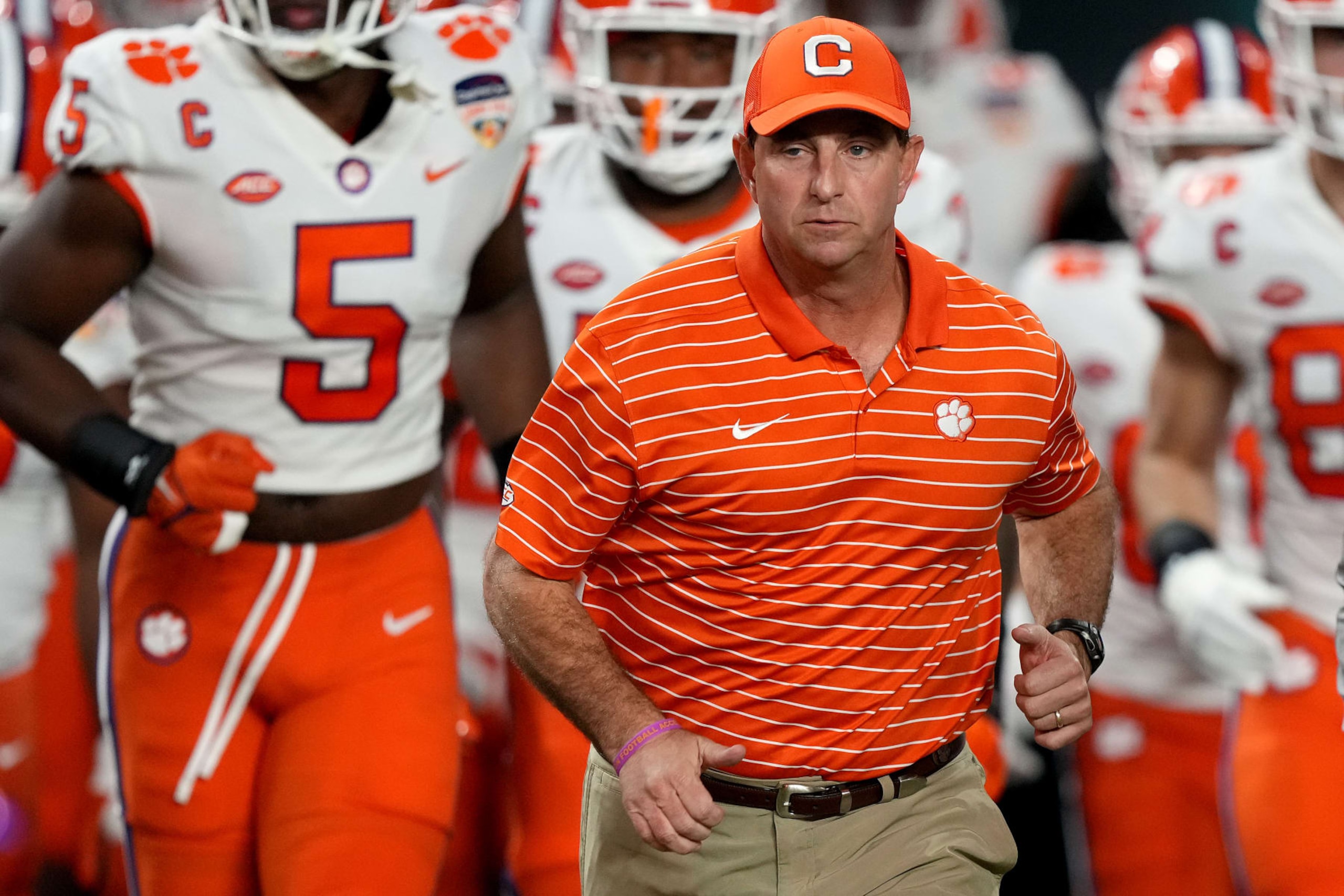 MIAMI GARDENS, FLORIDA - DECEMBER 30: Head coach Dabo Swinney of the Clemson Tigers runs to the field prior to the Capital One Orange Bowl against the Tennessee Volunteers at Hard Rock Stadium on December 30, 2022 in Miami Gardens, Florida. (Photo by Eric Espada/Getty Images)