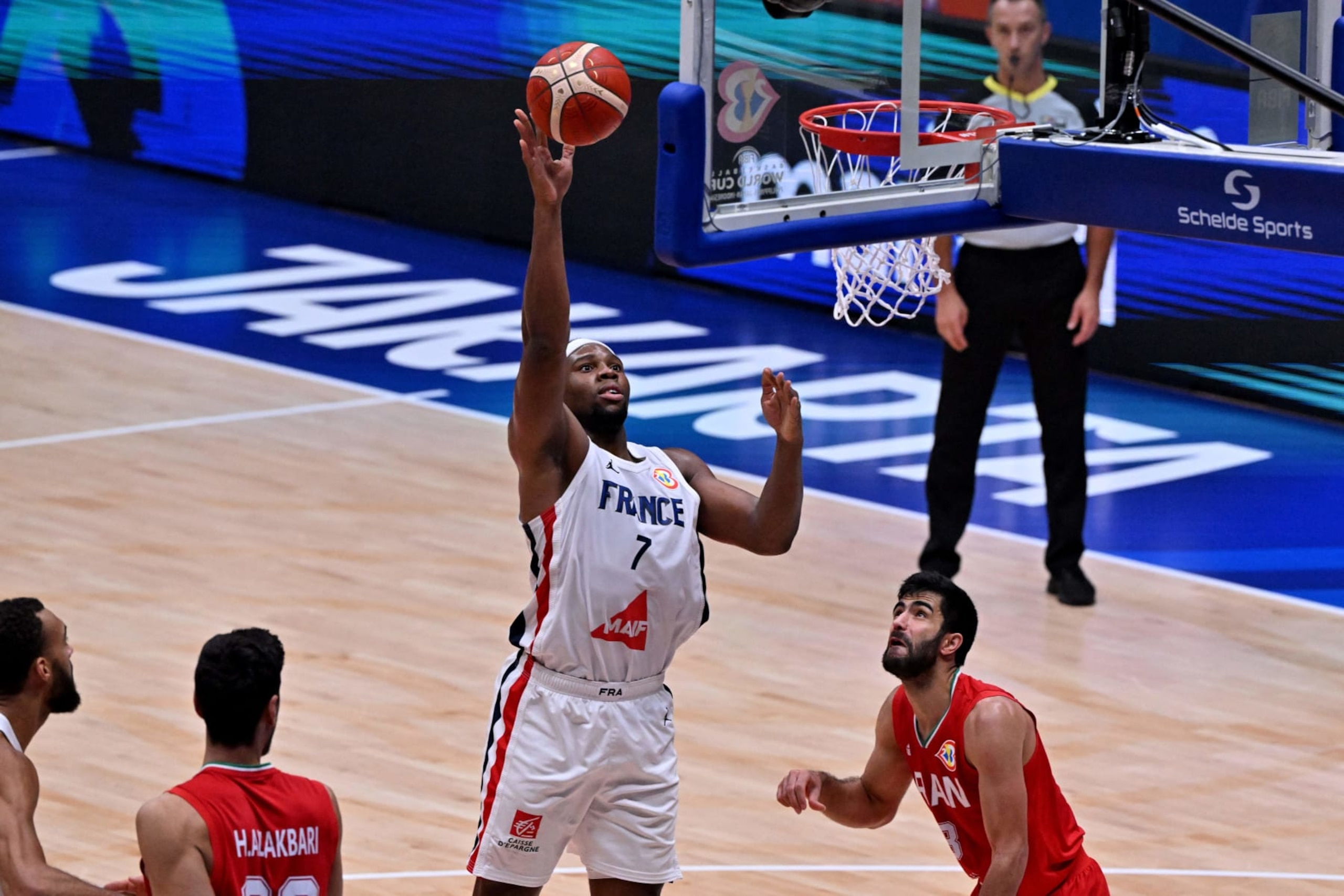 France's Guerchon Yabusele (7) shoots as Iran's Hasan Aliakbari (L) looks on during the FIBA Basketball World Cup match between Iran and France at the Indonesia Arena in Jakarta on August 31, 2023. (Photo by ADEK BERRY / AFP) (Photo by ADEK BERRY/AFP via Getty Images)