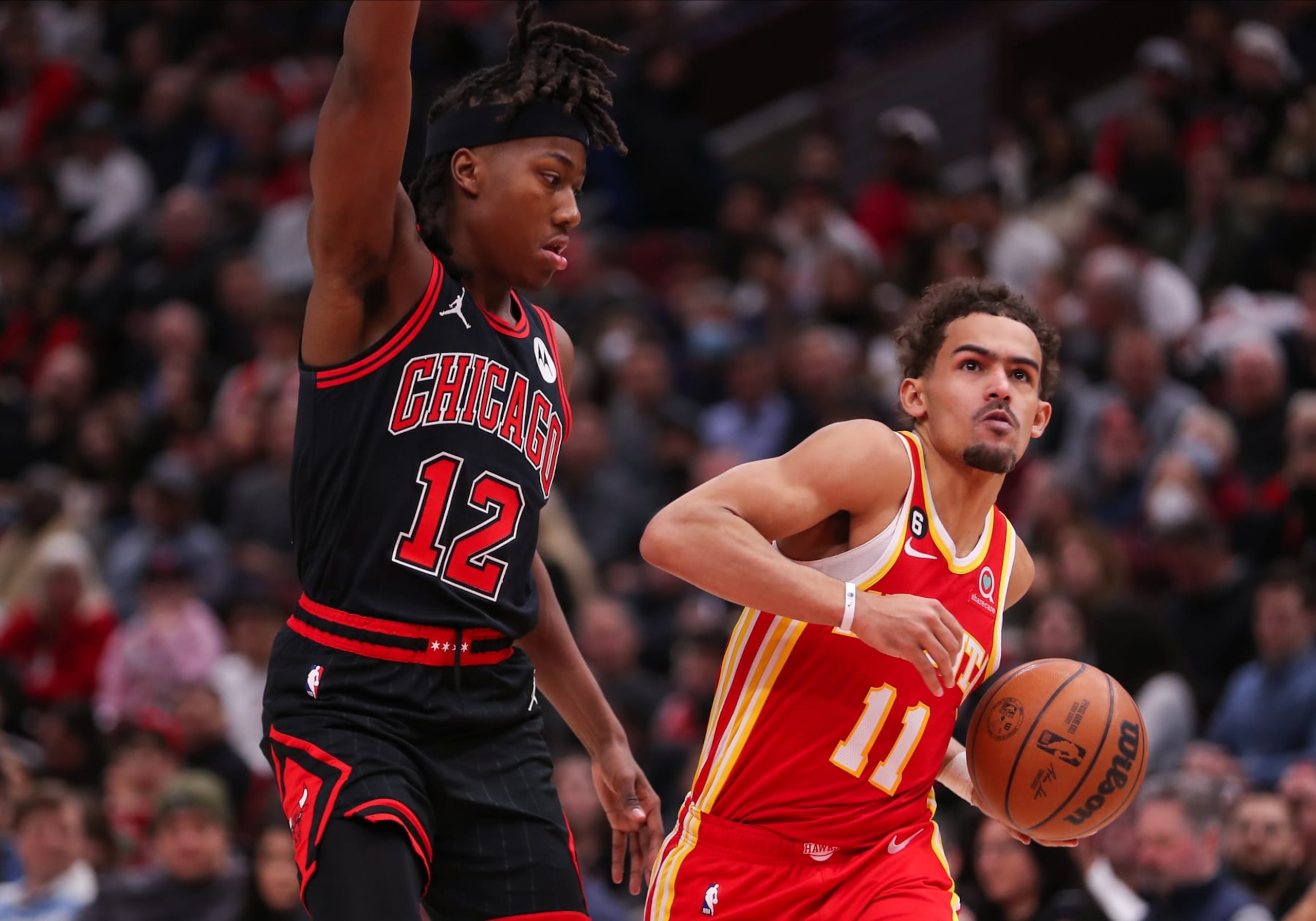 CHICAGO, IL - JANUARY 23: Atlanta Hawks Guard Trae Young (11) drives to the basket past Chicago Bulls Guard Ayo Dosunmu (12) during a NBA game between the Atlanta  Hawks and the Chicago Bulls on January 23, 2023 at the United Center in Chicago, IL. (Photo by Melissa Tamez/Icon Sportswire via Getty Images)