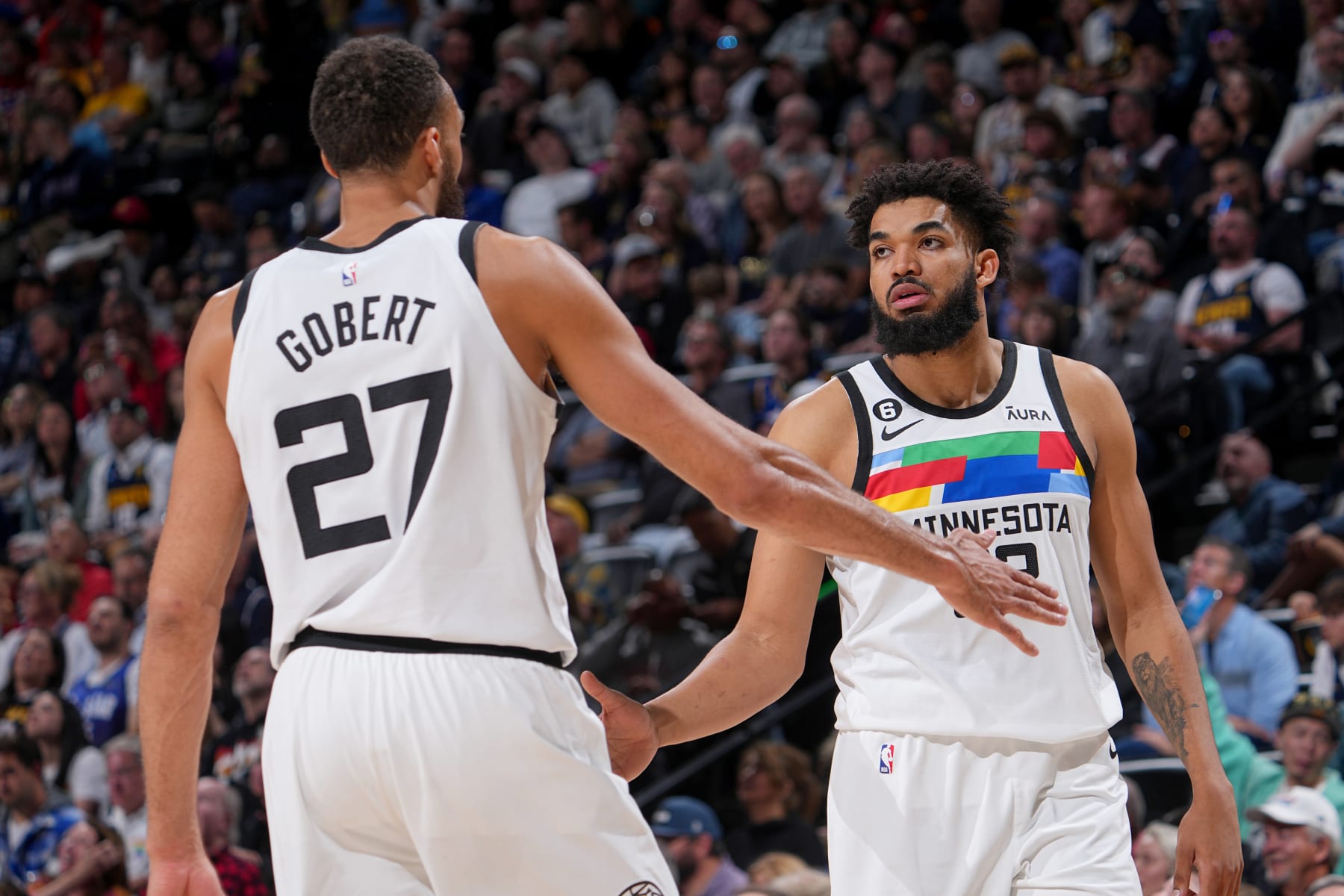 DENVER, CO - APRIL 19:  Rudy Gobert #27 of the Minnesota Timberwolves high fives Karl-Anthony Towns #32 during the game against the Denver Nuggets during Round One Game Two of the 2023 NBA Playoffs on April 19, 2023 at the Ball Arena in Denver, Colorado. NOTE TO USER: User expressly acknowledges and agrees that, by downloading and/or using this Photograph, user is consenting to the terms and conditions of the Getty Images License Agreement. Mandatory Copyright Notice: Copyright 2023 NBAE (Photo by Bart Young/NBAE via Getty Images)