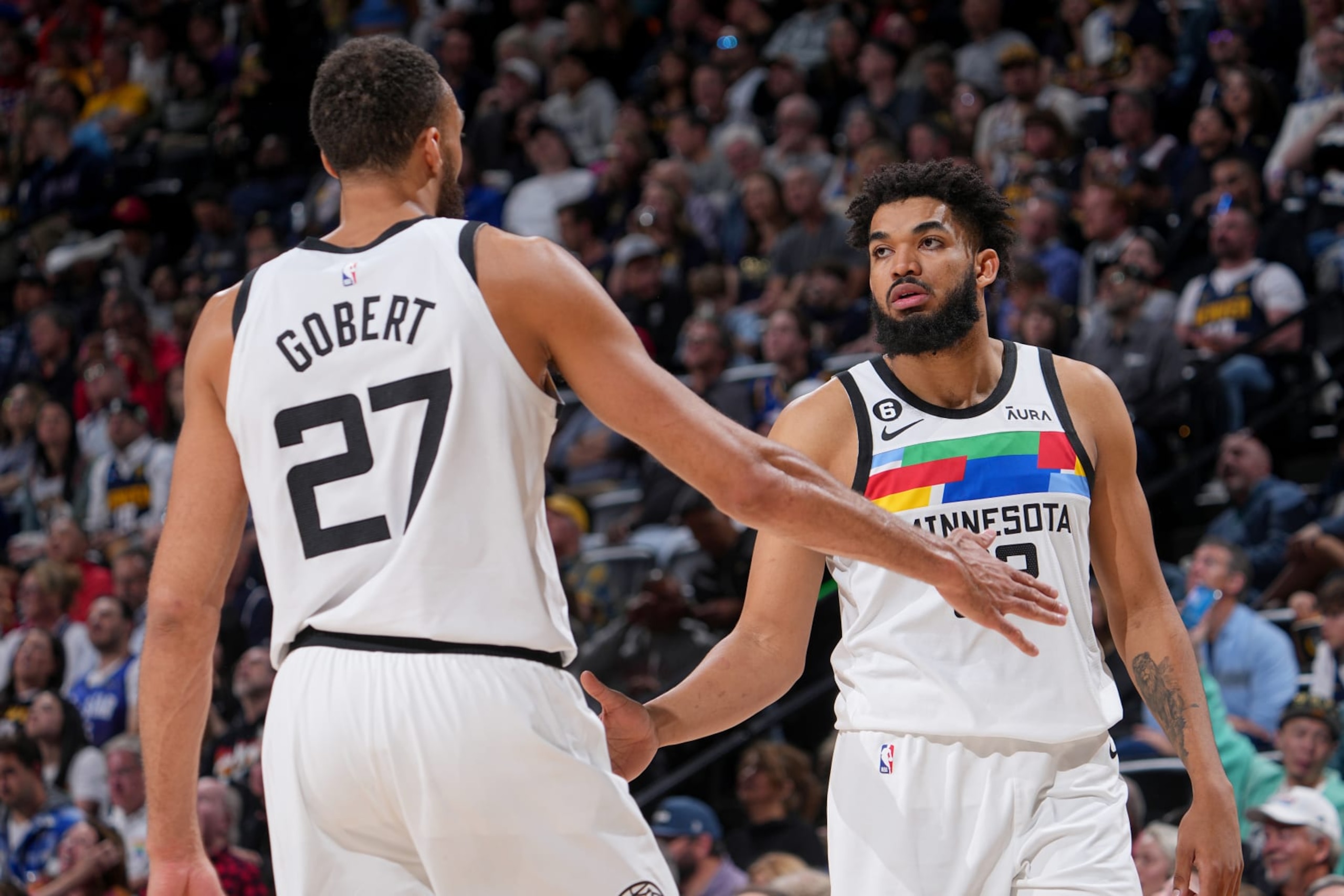 DENVER, CO - APRIL 19:  Rudy Gobert #27 of the Minnesota Timberwolves high fives Karl-Anthony Towns #32 during the game against the Denver Nuggets during Round One Game Two of the 2023 NBA Playoffs on April 19, 2023 at the Ball Arena in Denver, Colorado. NOTE TO USER: User expressly acknowledges and agrees that, by downloading and/or using this Photograph, user is consenting to the terms and conditions of the Getty Images License Agreement. Mandatory Copyright Notice: Copyright 2023 NBAE (Photo by Bart Young/NBAE via Getty Images)