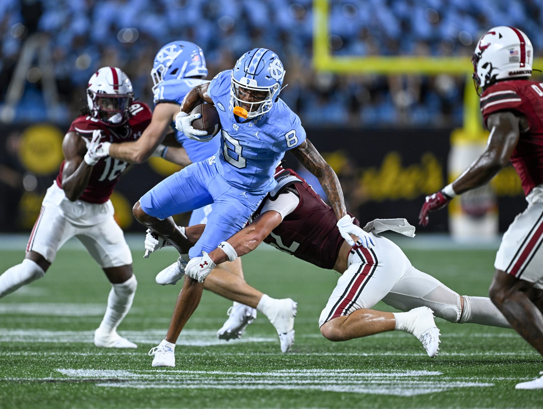 CHARLOTTE, NORTH CAROLINA - SEPTEMBER 02: Stone Blanton #52 of the South Carolina Gamecocks tackles Kobe Paysour #8 of the North Carolina Tar Heels during the first half of the game at Bank of America Stadium on September 02, 2023 in Charlotte, North Carolina. (Photo by Grant Halverson/Getty Images)