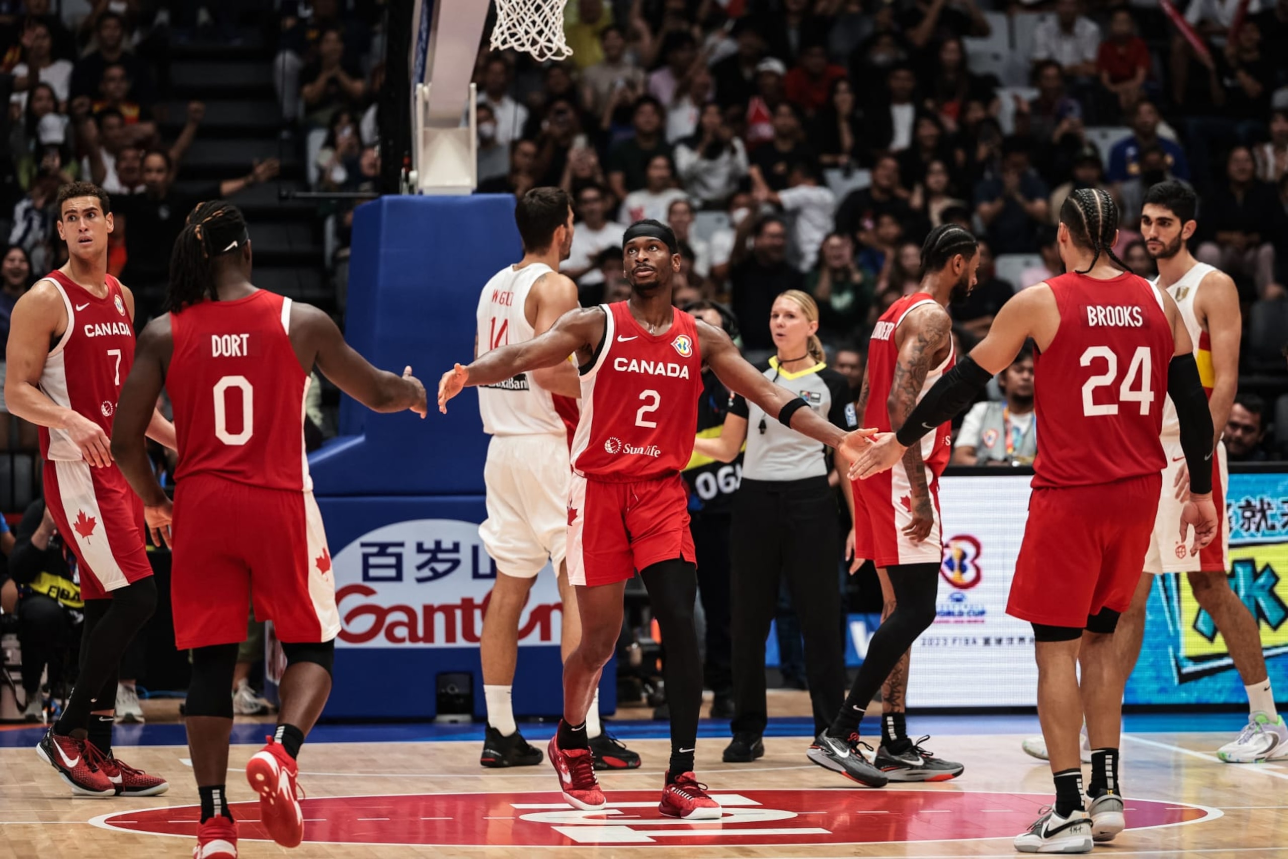 Canada's Shai Gilgeous-Alexander (C) reacts with teammates as he shoots a  free throw during the FIBA Basketball World Cup group L match between Spain and Canada at Indonesia Arena in Jakarta on September 3, 2023. (Photo by Yasuyoshi CHIBA / AFP) (Photo by YASUYOSHI CHIBA/AFP via Getty Images)