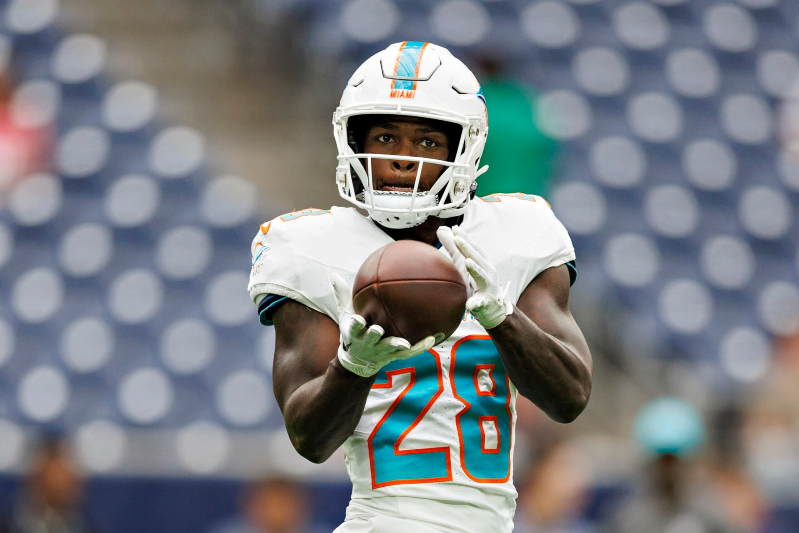 HOUSTON, TEXAS - AUGUST 19:  DeVon Achane #28 of the Miami Dolphins warms up before the preseason game against the Houston Texans at NRG Stadium on August 19, 2023 in Houston, Texas. The Dolphins defeated the Texans 28-3.  (Photo by Wesley Hitt/Getty Images)