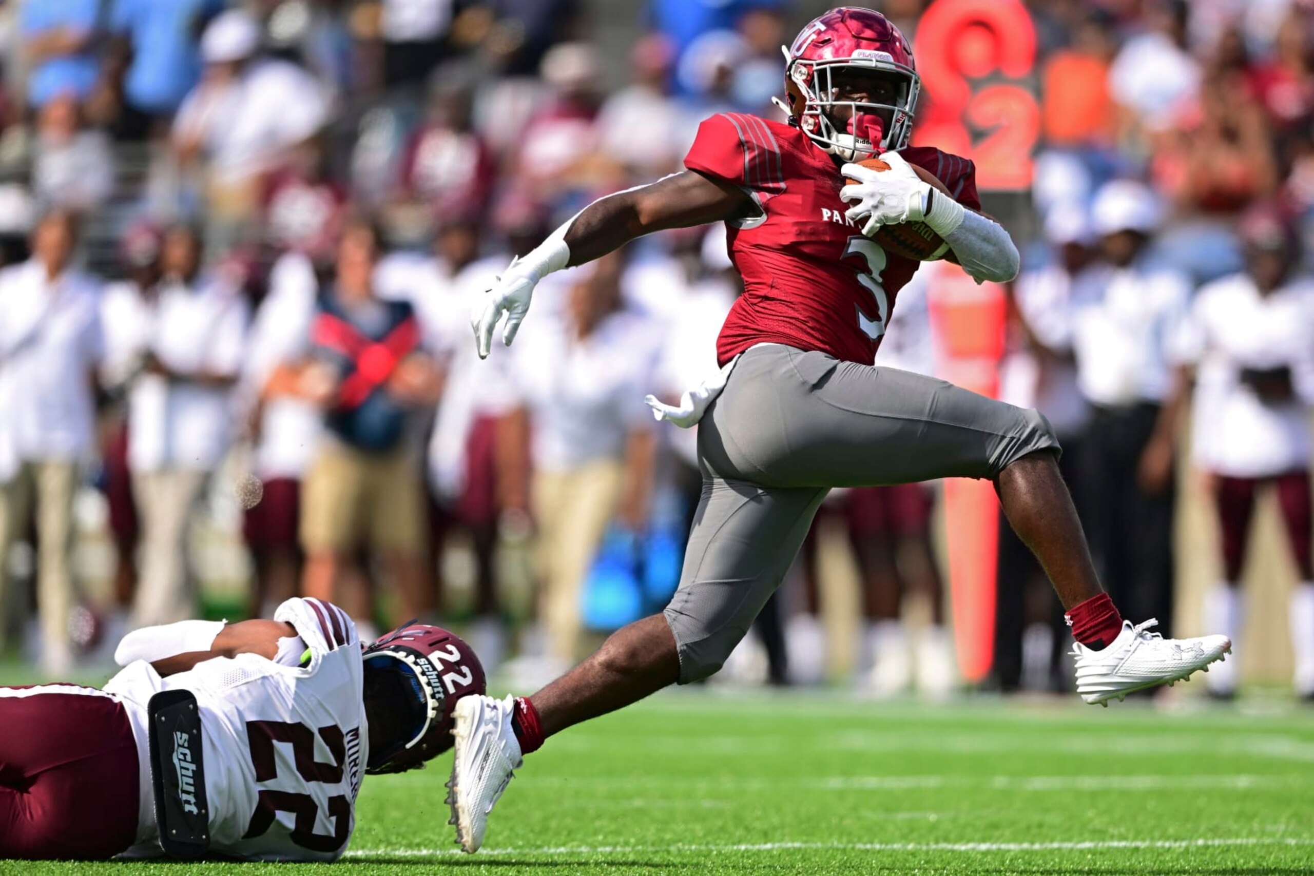 Virginia Union running back Jada Byers steps out of an attempted tackle by Morehouse defensive back Cameron Selders to score a 29-yard touchdown during the first quarter of an NCAA college football game, Sunday, Sept. 3, 2023, in Canton, Ohio. (AP Photo/David Dermer)