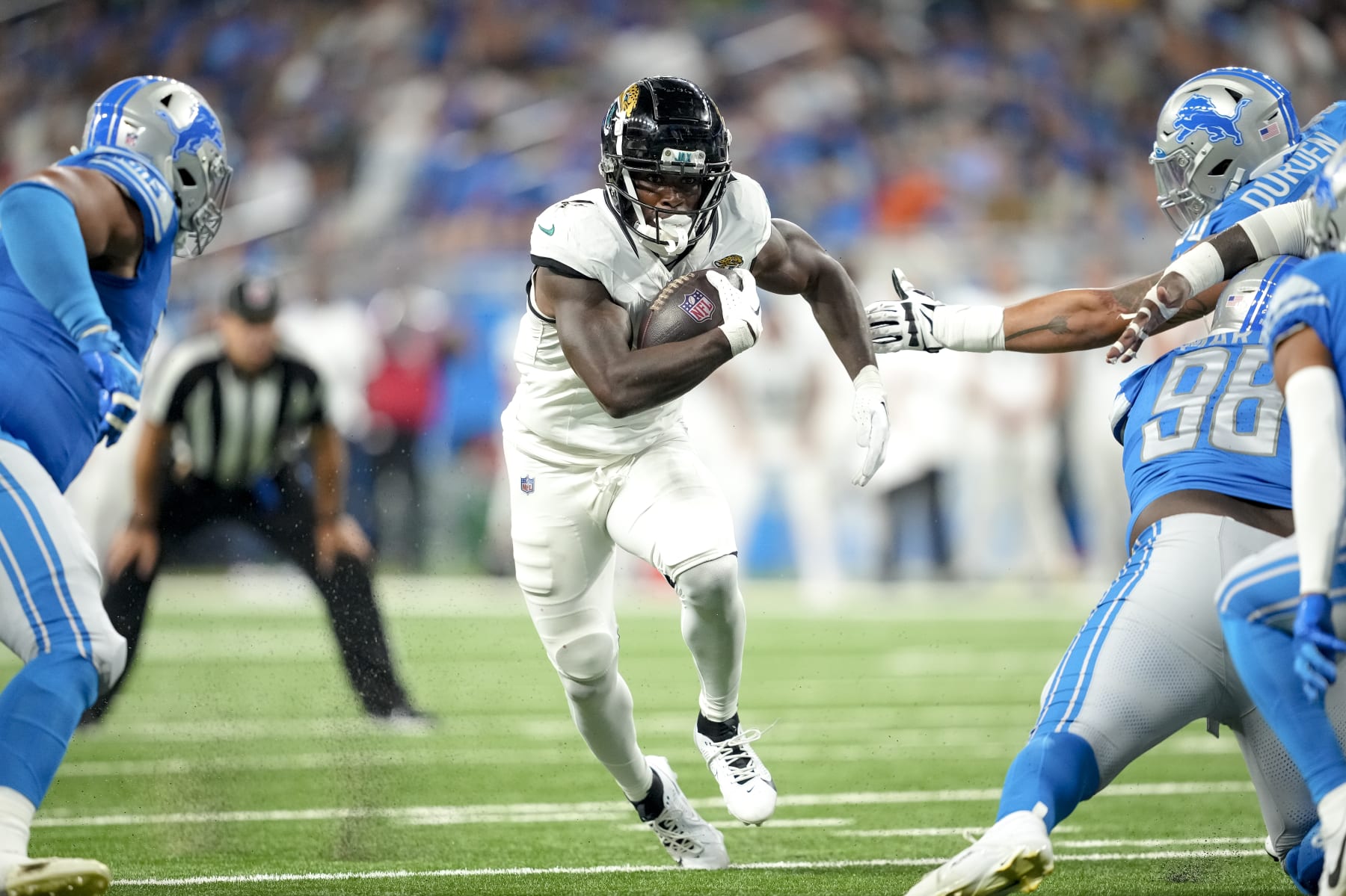 DETROIT, MICHIGAN - AUGUST 19: Tank Bigsby #4 of the Jacksonville Jaguars runs the ball against the Detroit Lions during the second quarter of the preseason game at Ford Field on August 19, 2023 in Detroit, Michigan. (Photo by Nic Antaya/Getty Images)