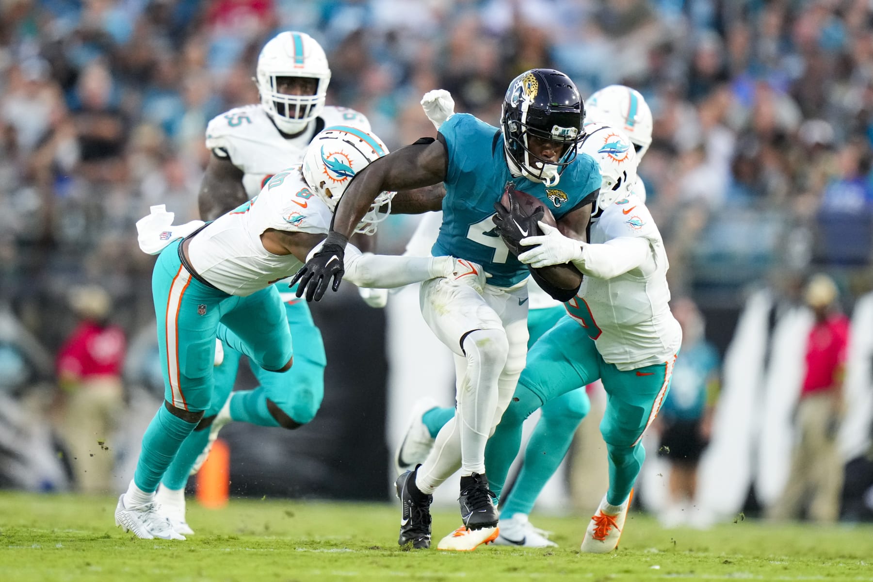 JACKSONVILLE, FLORIDA - AUGUST 26: Tank Bigsby #4 of the Jacksonville Jaguars runs the ball against the Miami Dolphins during the second quarter at TIAA Bank Field on August 26, 2023 in Jacksonville, Florida. (Photo by Rich Storry/Getty Images)