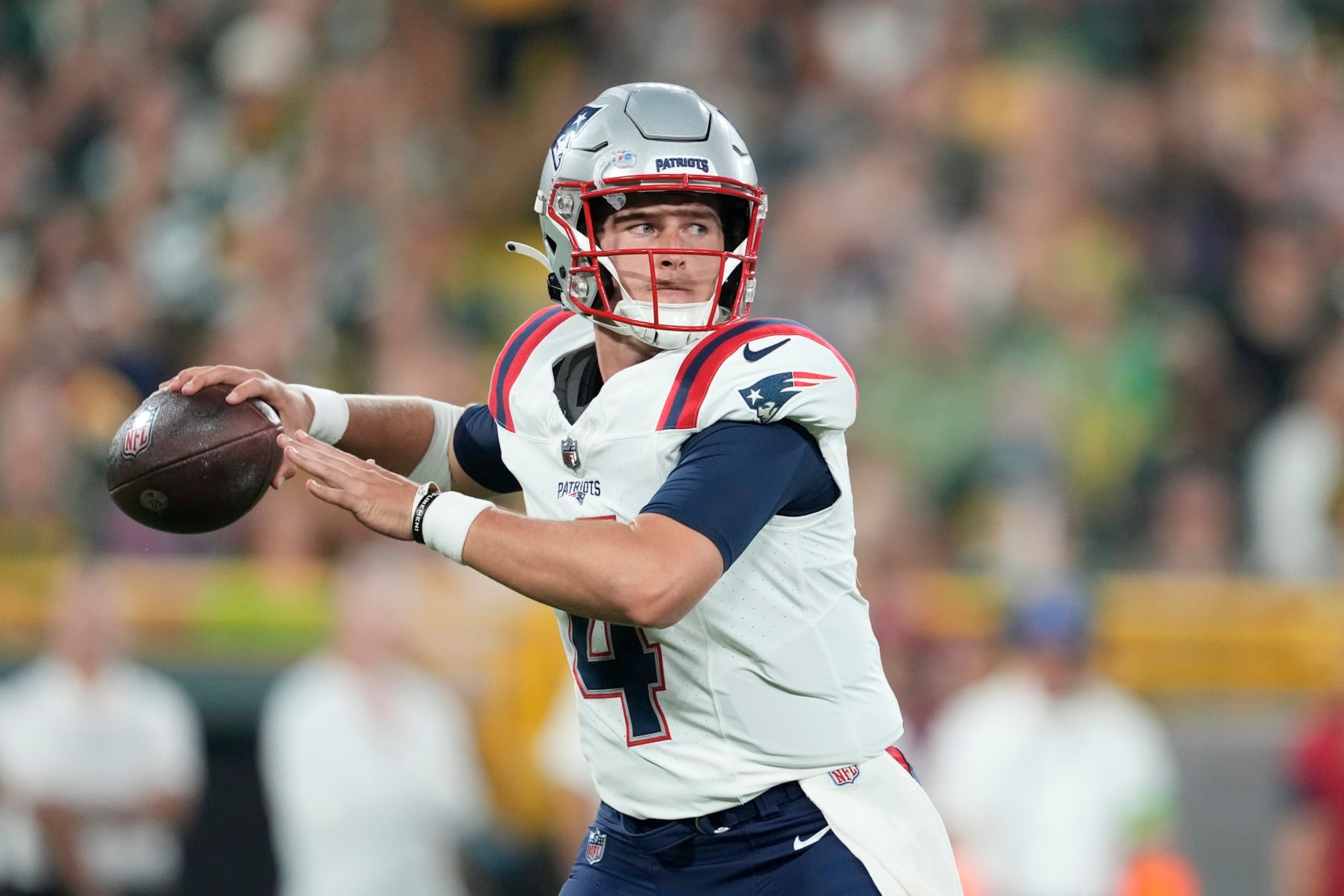 GREEN BAY, WISCONSIN - AUGUST 19: Bailey Zappe #4 of the New England Patriots looks to throw a pass in the second quarter against the Green Bay Packers during a preseason game at Lambeau Field on August 19, 2023 in Green Bay, Wisconsin. (Photo by Patrick McDermott/Getty Images)