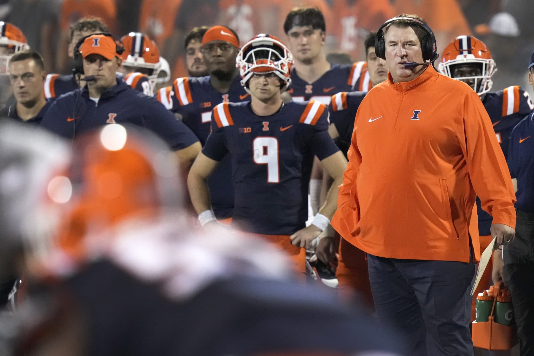Illinois head coach Brett Bielema watches the defense from the sidelines with quarterback Luke Altmyer nearby during an NCAA college football game against Toledo Saturday, Sept. 2, 2023, in Champaign, Ill. (AP Photo/Charles Rex Arbogast)