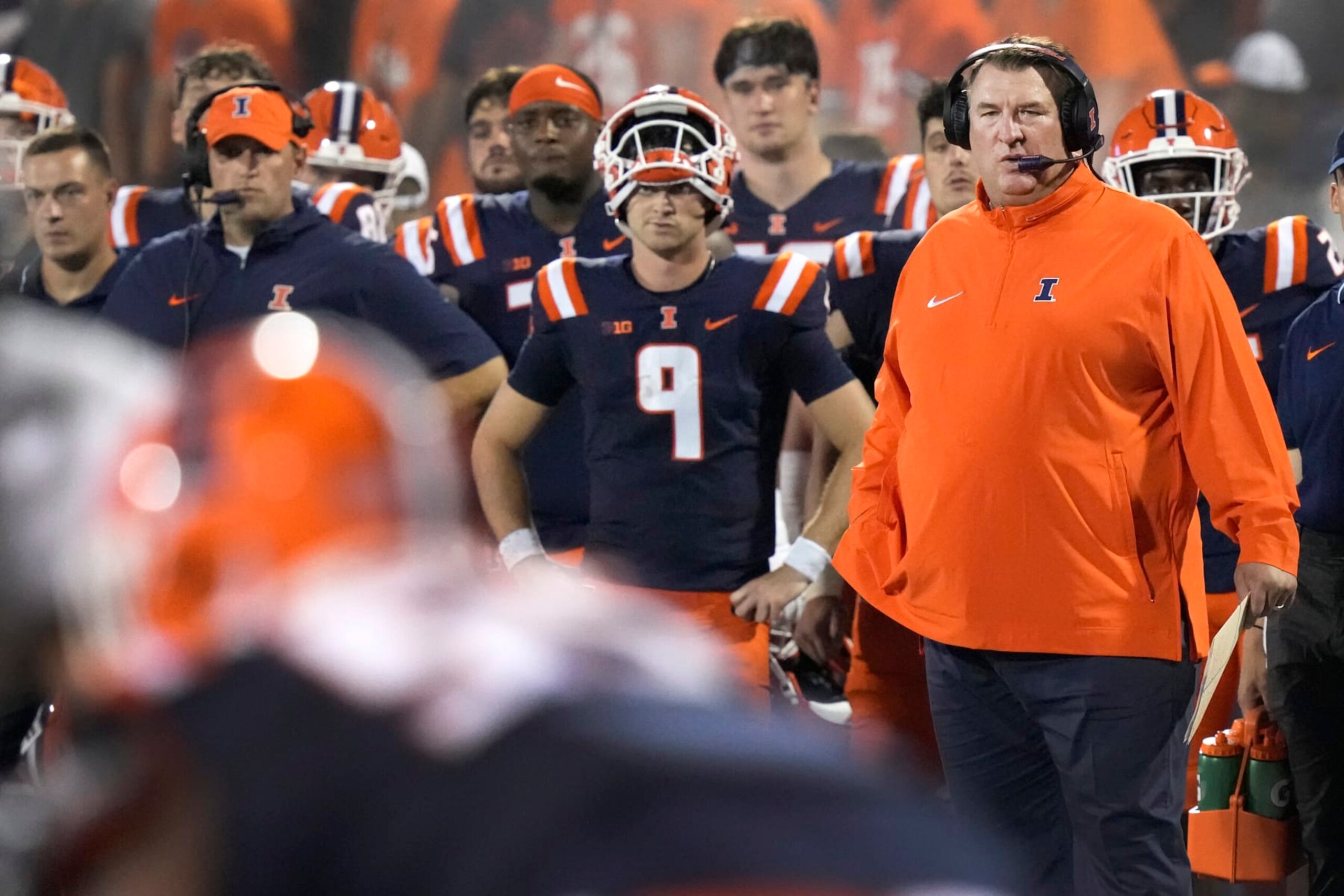 Illinois head coach Brett Bielema watches the defense from the sidelines with quarterback Luke Altmyer nearby during an NCAA college football game against Toledo Saturday, Sept. 2, 2023, in Champaign, Ill. (AP Photo/Charles Rex Arbogast)