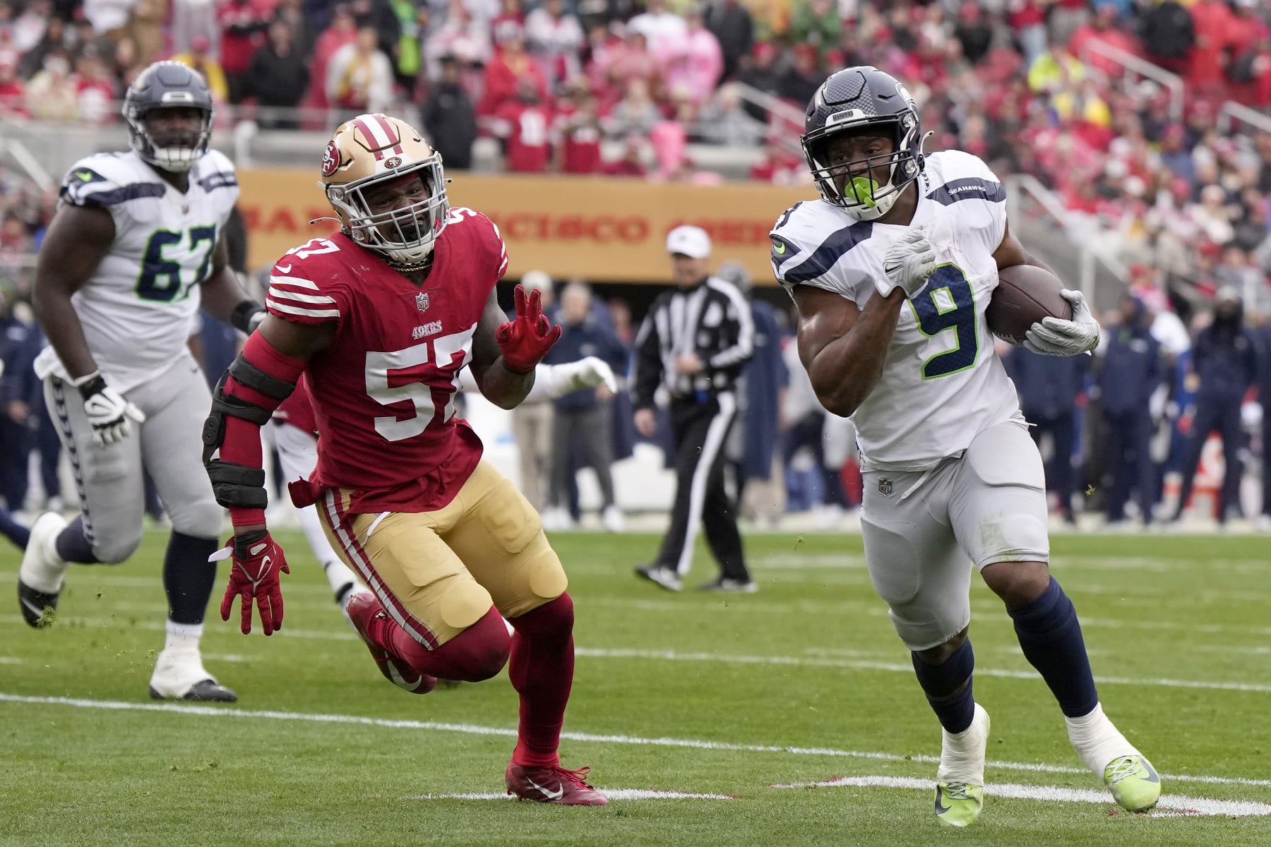 SANTA CLARA, CALIFORNIA - JANUARY 14: Kenneth Walker III #9 of the Seattle Seahawks runs the ball to score a 7 yard touchdown against the San Francisco 49ers during the second quarter in the NFC Wild Card playoff game at Levi's Stadium on January 14, 2023 in Santa Clara, California. (Photo by Thearon W. Henderson/Getty Images)
