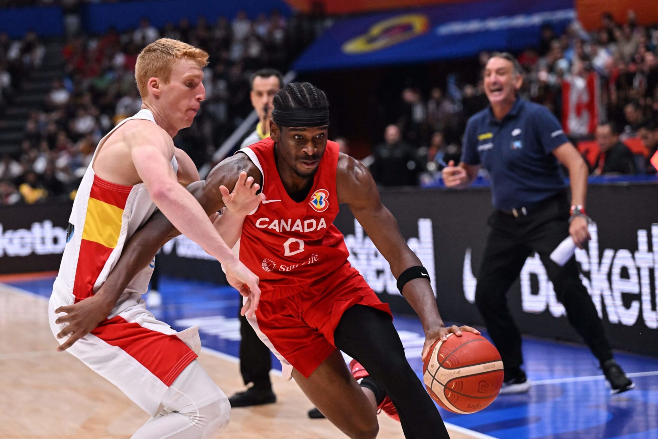 Canada's Shai Gilgeous-Alexander (R) dribbles as Brazil's Alberto Diaz (L) tries to block during the FIBA Basketball World Cup match between Spain and Canada at Indonesia Arena in Jakarta on September 3, 2023. (Photo by ADEK BERRY / AFP) (Photo by ADEK BERRY/AFP via Getty Images)